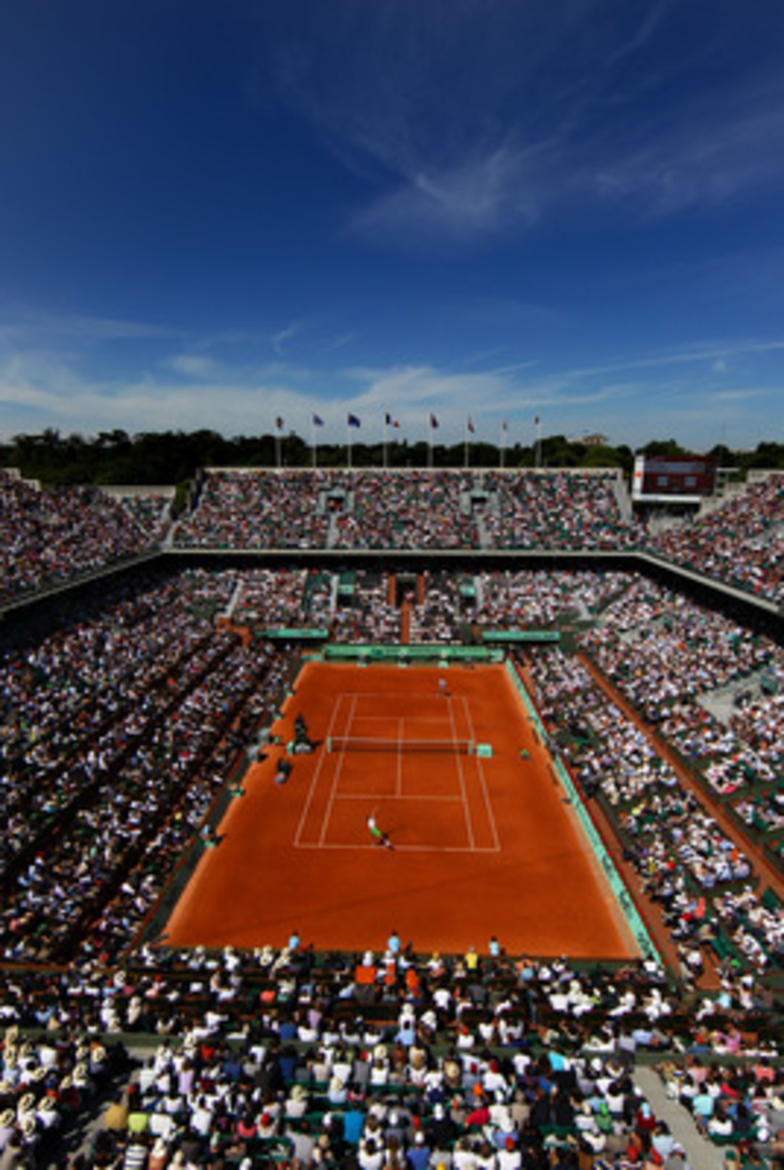 PARIS, FRANCE - MAY 28:  Gilles Simon of France serves in front of a packed Court Philippe Chatrier during the men's singles round three match between Mardy Fish of USA and Gilles Simon of France on day seven of the French Open at Roland Garros on May 28,