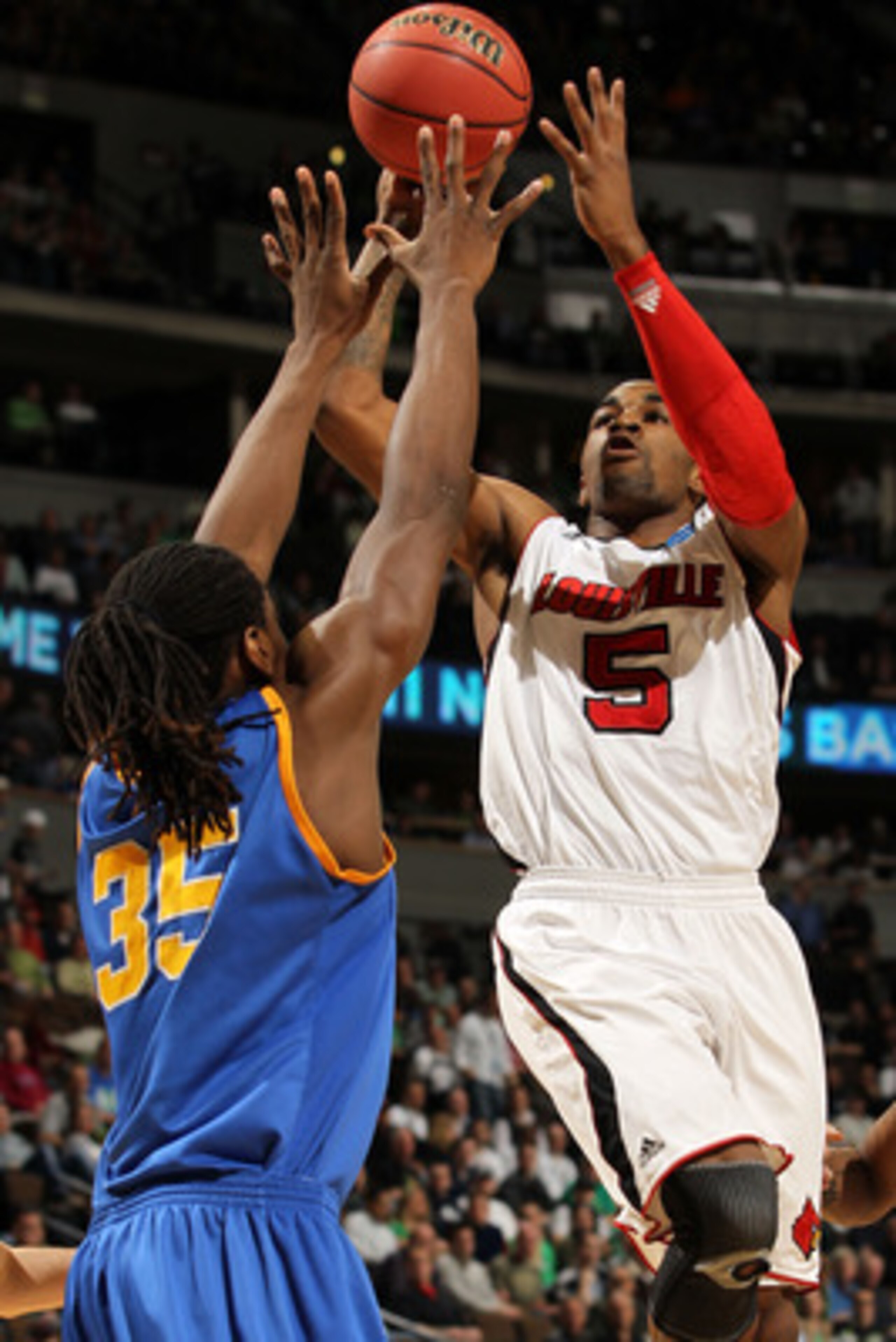 DENVER, CO - MARCH 17:  Chris Smith #5 of the Louisville Cardinals shoots the ball over Kenneth Faried #35 of the Morehead State Eagles during the second round of the 2011 NCAA men's basketball tournament at Pepsi Center on March 17, 2011 in Denver, Color