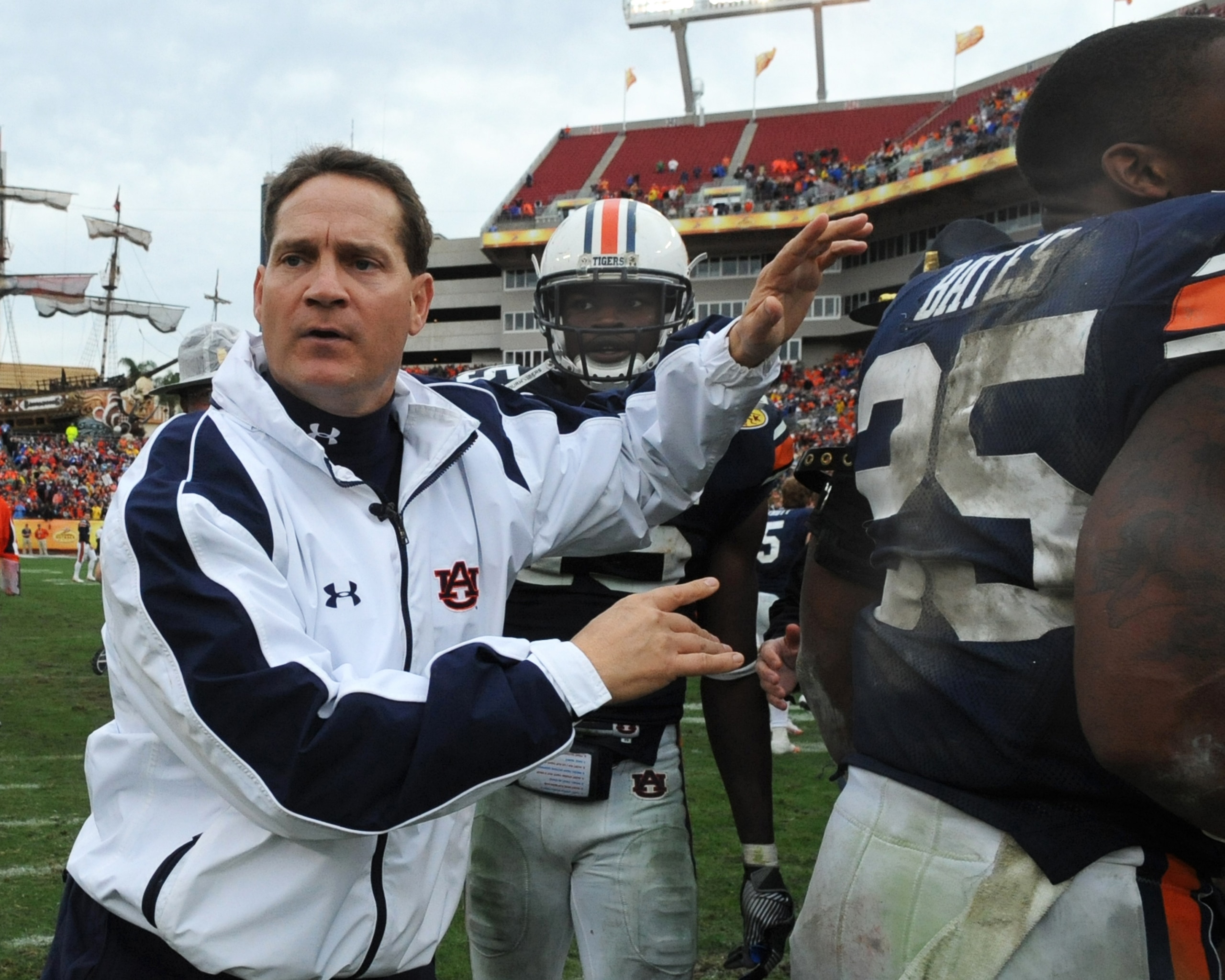 TAMPA, FL - JANUARY 1: Coach Gene Chizik of the Auburn Tigers moves players from the field before overtime against the Northwestern Wildcats in the Outback Bowl January 1, 2010 at Raymond James Stadium in Tampa, Florida.  (Photo by Al Messerschmidt/Getty