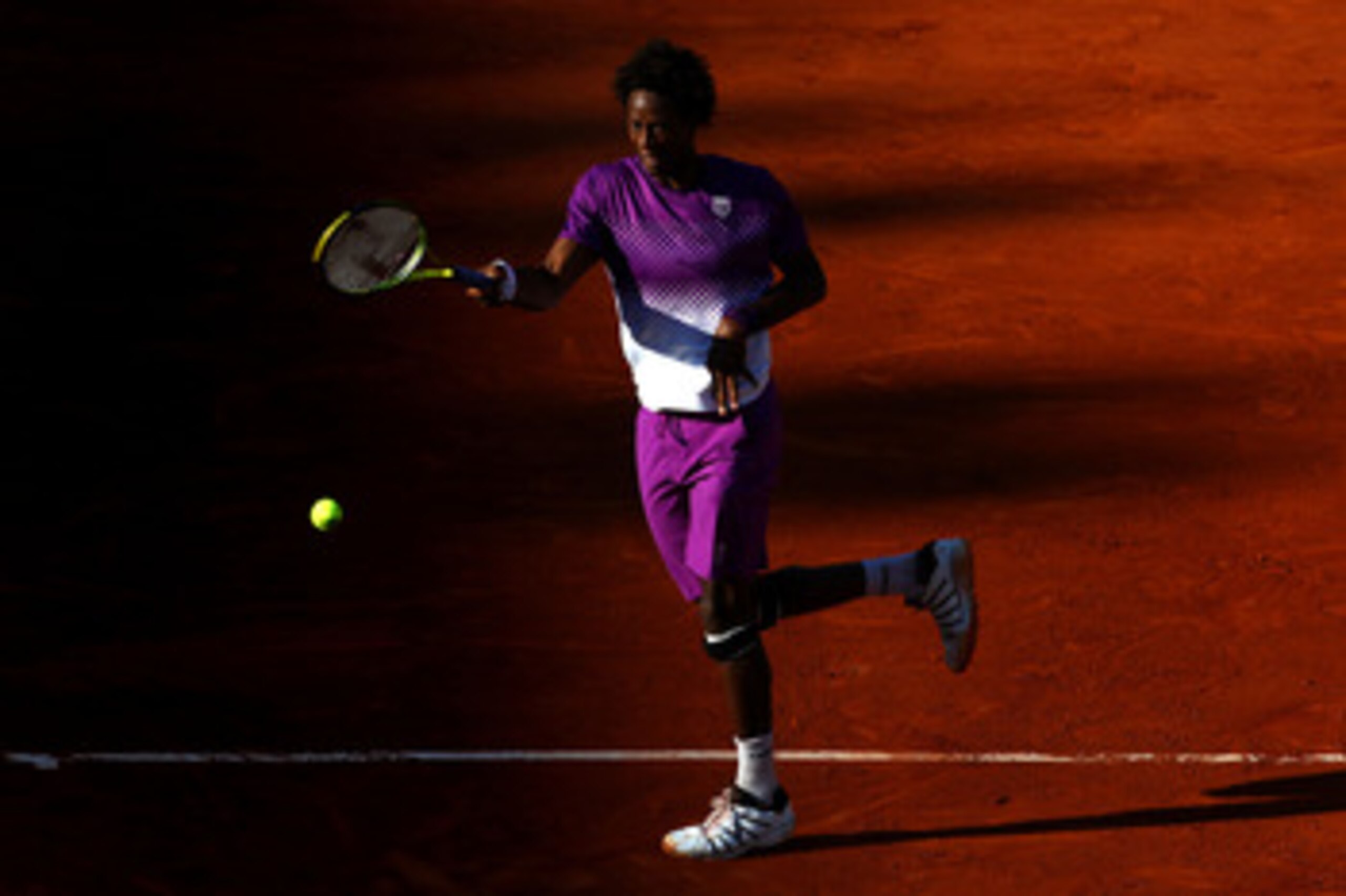PARIS, FRANCE - MAY 31:  Gael Monfils of France hits a forehand during the men's singles quarterfinal match between Gael Monfils of France and Roger Federer of Switzerland on day ten of the French Open at Roland Garros on May 31, 2011 in Paris, France.  (