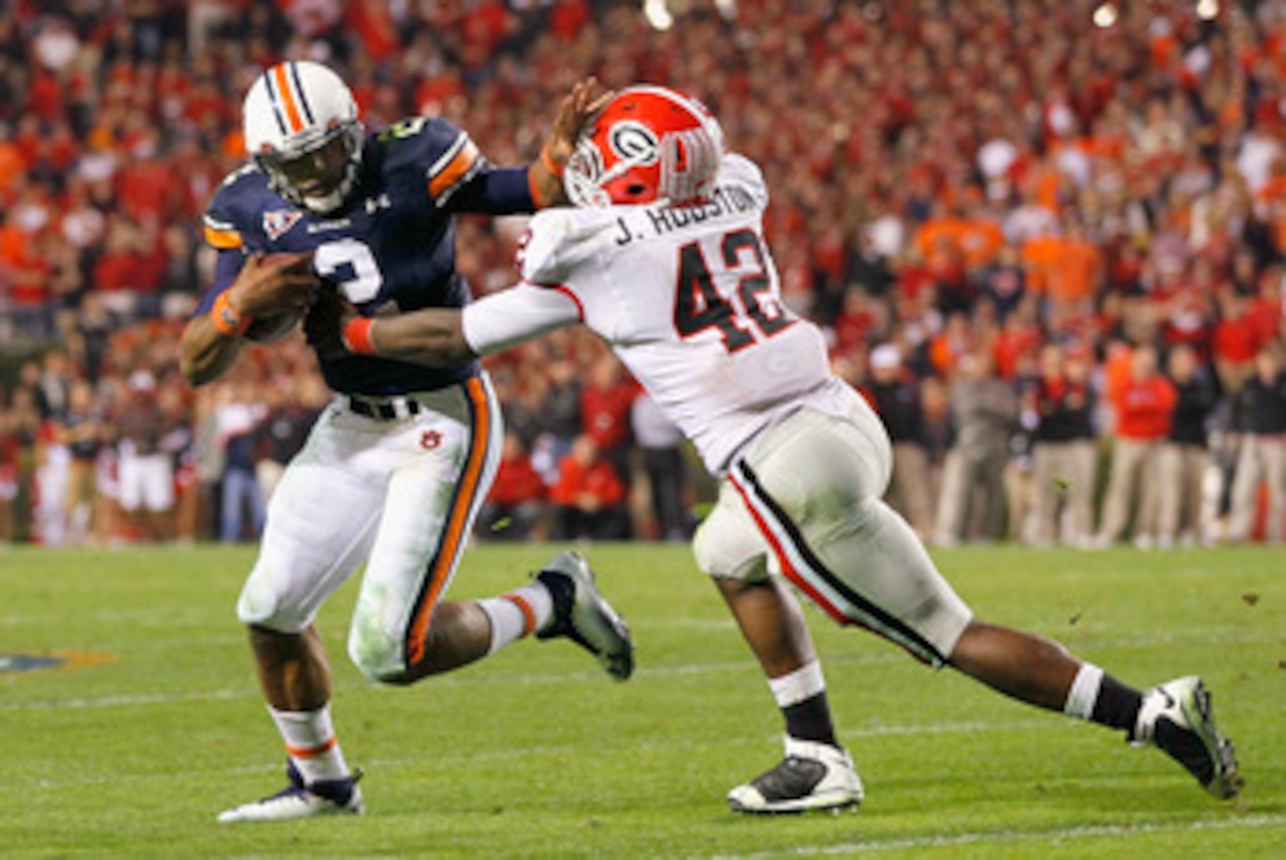AUBURN, AL - NOVEMBER 13:  Quarterback Cameron Newton #2 of the Auburn Tigers breaks a tackle by Justin Houston #42 of the Georgia Bulldogs at Jordan-Hare Stadium on November 13, 2010 in Auburn, Alabama.  (Photo by Kevin C. Cox/Getty Images)
