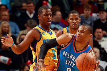 NEW ORLEANS, LA - DECEMBER 10:  Russell Westbrook #0 of the Oklahoma City Thunder passes the ball around Chris Paul #3 of the New Orleans Hornets  at New Orleans Arena on December 10, 2010 in New Orleans, Louisiana.    The Thunder defeated the Hornets 97-