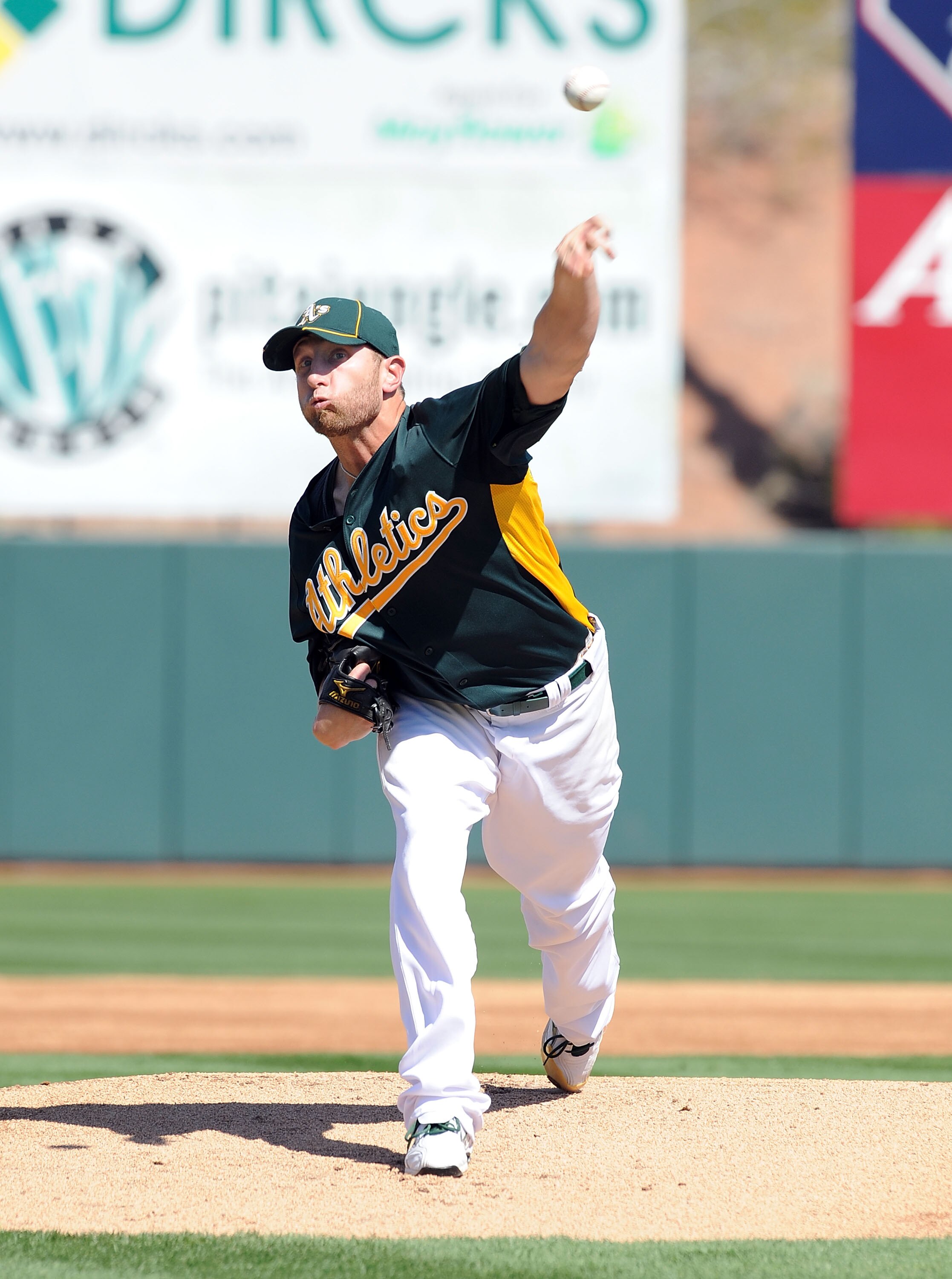 PHOENIX, AZ - MARCH 04:  Dallas Braden #51 of the Oakland Athletics delivers a pitch against the Texas Rangers at Phoenix Municipal Stadium on March 4, 2011 in Phoenix, Arizona.  (Photo by Norm Hall/Getty Images)