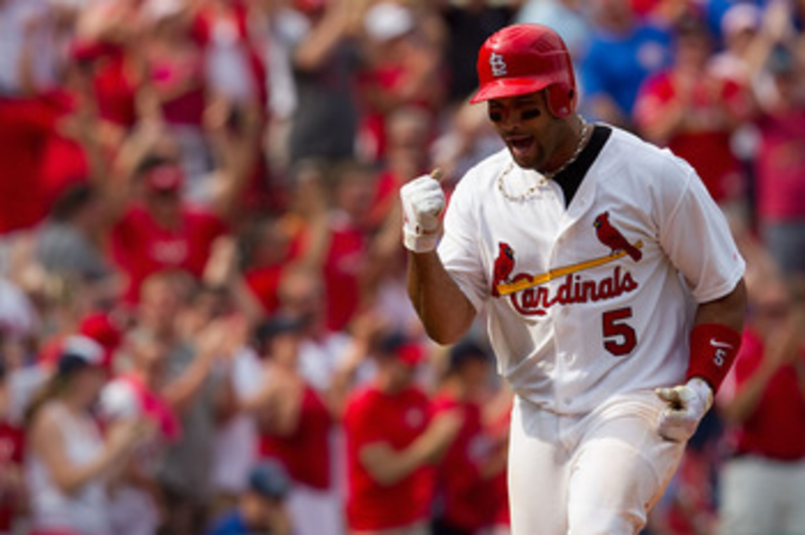 ST. LOUIS, MO - JUNE 5: Albert Pujols #5 of the St. Louis Cardinals celebrates his walk-off home run against the Chicago Cubs at Busch Stadium on June 5, 2011 in St. Louis, Missouri.  The Cardinals beat the Cubs 3-2 in 10 innings.  (Photo by Dilip Vishwan