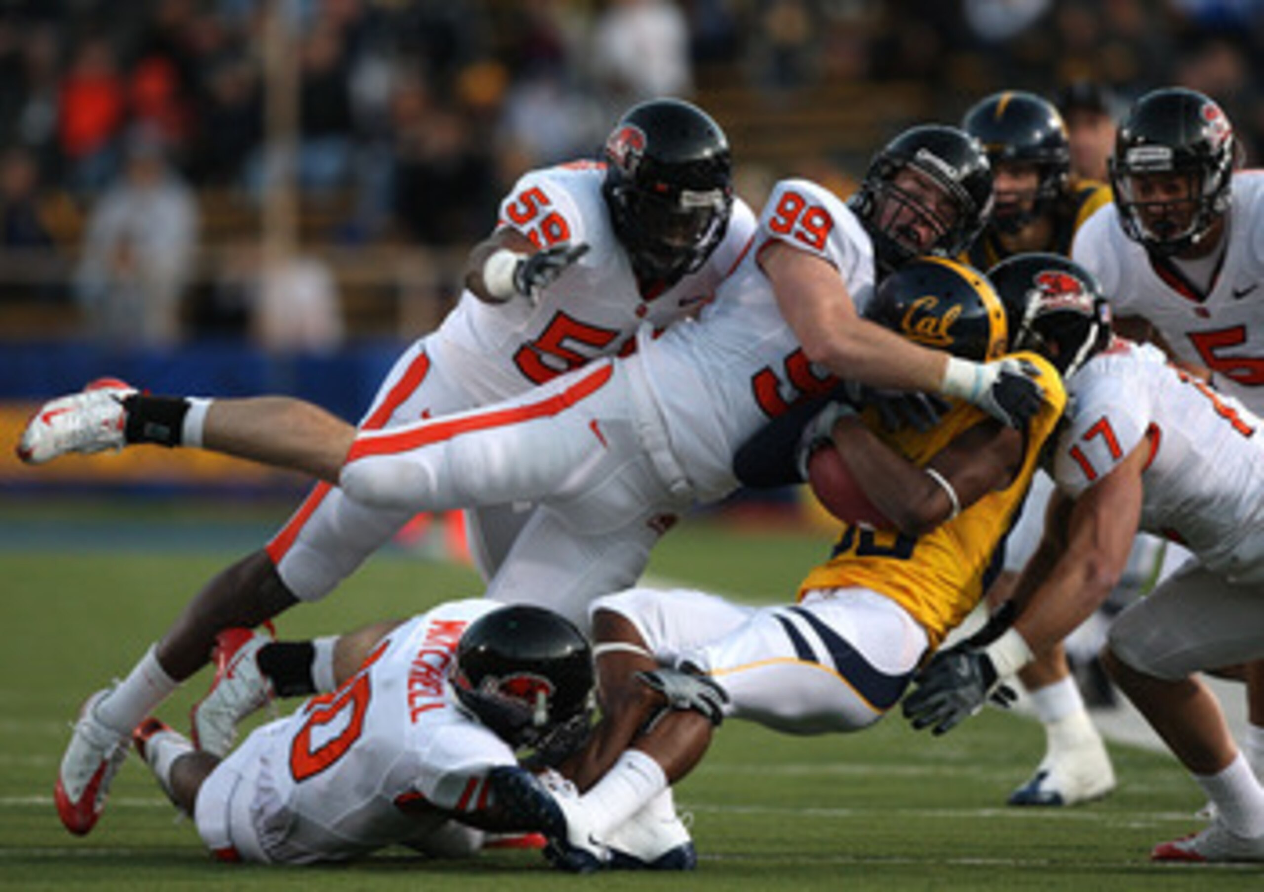 BERKELEY, CA - NOVEMBER 07:  Verran Tucker #86 of the California Golden Bears is tackled by Gabe Miller #99 of the Oregon State Beavers at California Memorial Stadium on November 7, 2009 in Berkeley, California.  (Photo by Jed Jacobsohn/Getty Images)