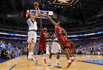 DALLAS, TX - JUNE 05:  Dirk Nowitzki #41 of the Dallas Mavericks attempts a shot against Udonis Haslem #40 and Juwan Howard #5 of the Miami Heat in the second half of Game Three of the 2011 NBA Finals at American Airlines Center on June 5, 2011 in Dallas,