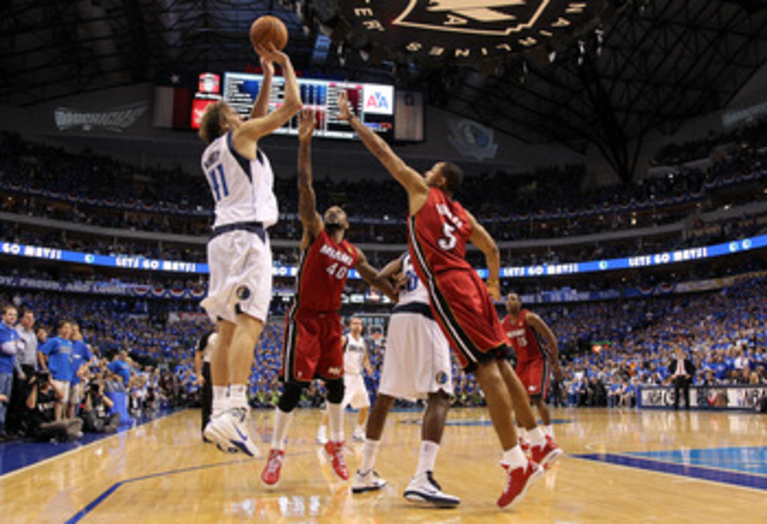 DALLAS, TX - JUNE 05:  Dirk Nowitzki #41 of the Dallas Mavericks attempts a shot against Udonis Haslem #40 and Juwan Howard #5 of the Miami Heat in the second half of Game Three of the 2011 NBA Finals at American Airlines Center on June 5, 2011 in Dallas,
