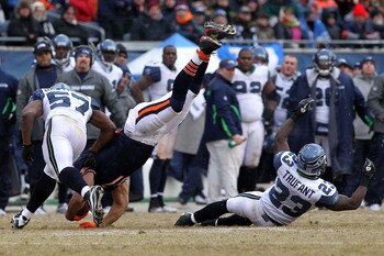 CHICAGO, IL - JANUARY 16:  Kellen Davis #87 of the Chicago Bears flips over after making a catch against David Hawthorne #57 of the Seattle Seahawks in the third quarter of the 2011 NFC divisional playoff game at Soldier Field on January 16, 2011 in Chica