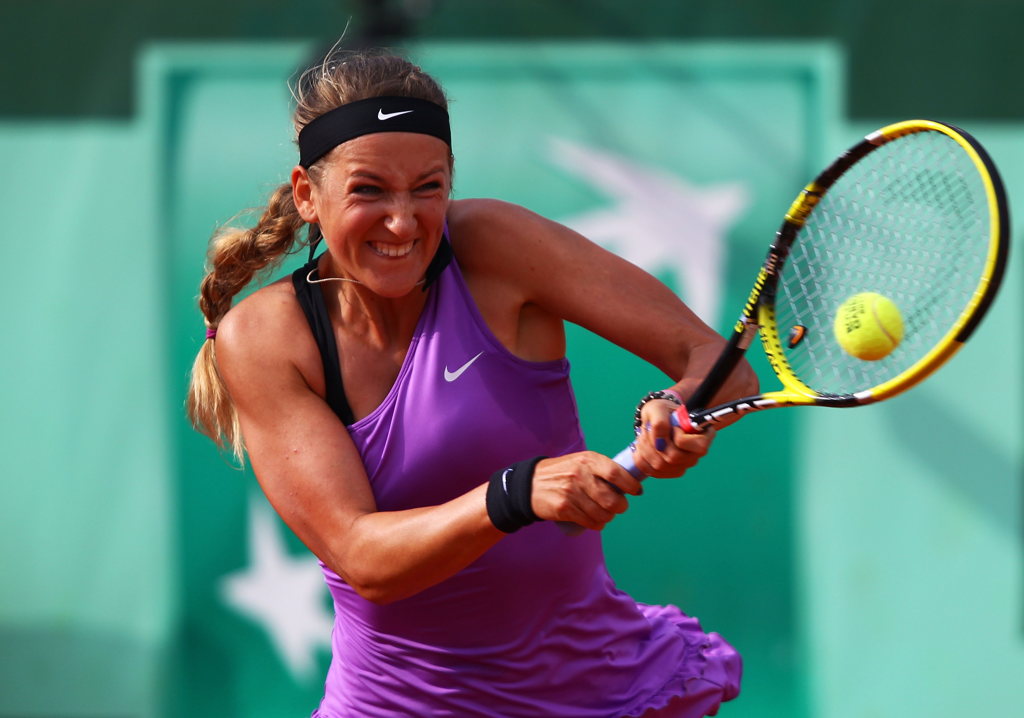 PARIS, FRANCE - MAY 30:  Victoria Azarenka of Belarus hits a backhand during the women's singles round four match between Ekaterina Makarova of Russia and Victoria Azarenka of Belarus on day nine of the French Open at Roland Garros on May 30, 2011 in Pari