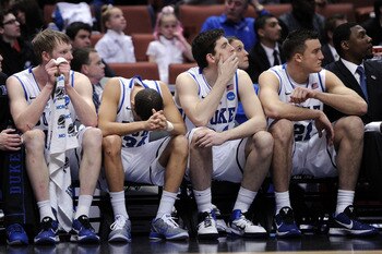ANAHEIM, CA - MARCH 24:  Kyle Singler #12, Seth Curry #30, Ryan Kelly #34 and Miles Plumlee #21 of the Duke Blue Devils look on from the bench against the Arizona Wildcats during the west regional semifinal of the 2011 NCAA men's basketball tournament at