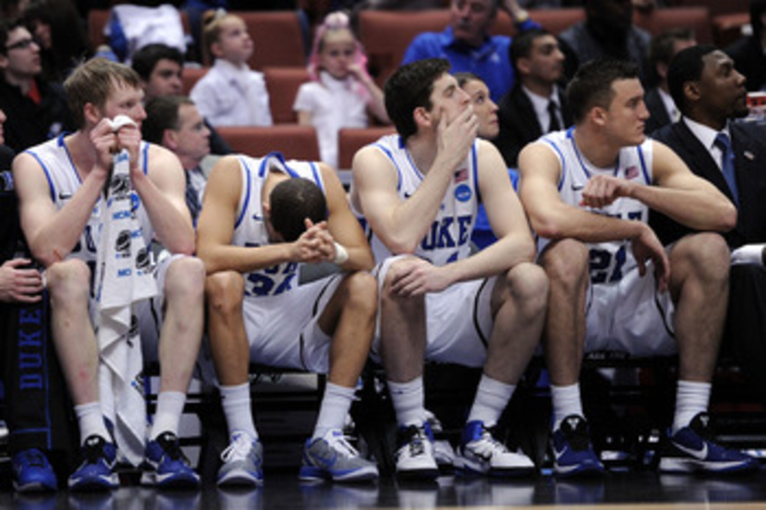 ANAHEIM, CA - MARCH 24:  Kyle Singler #12, Seth Curry #30, Ryan Kelly #34 and Miles Plumlee #21 of the Duke Blue Devils look on from the bench against the Arizona Wildcats during the west regional semifinal of the 2011 NCAA men's basketball tournament at
