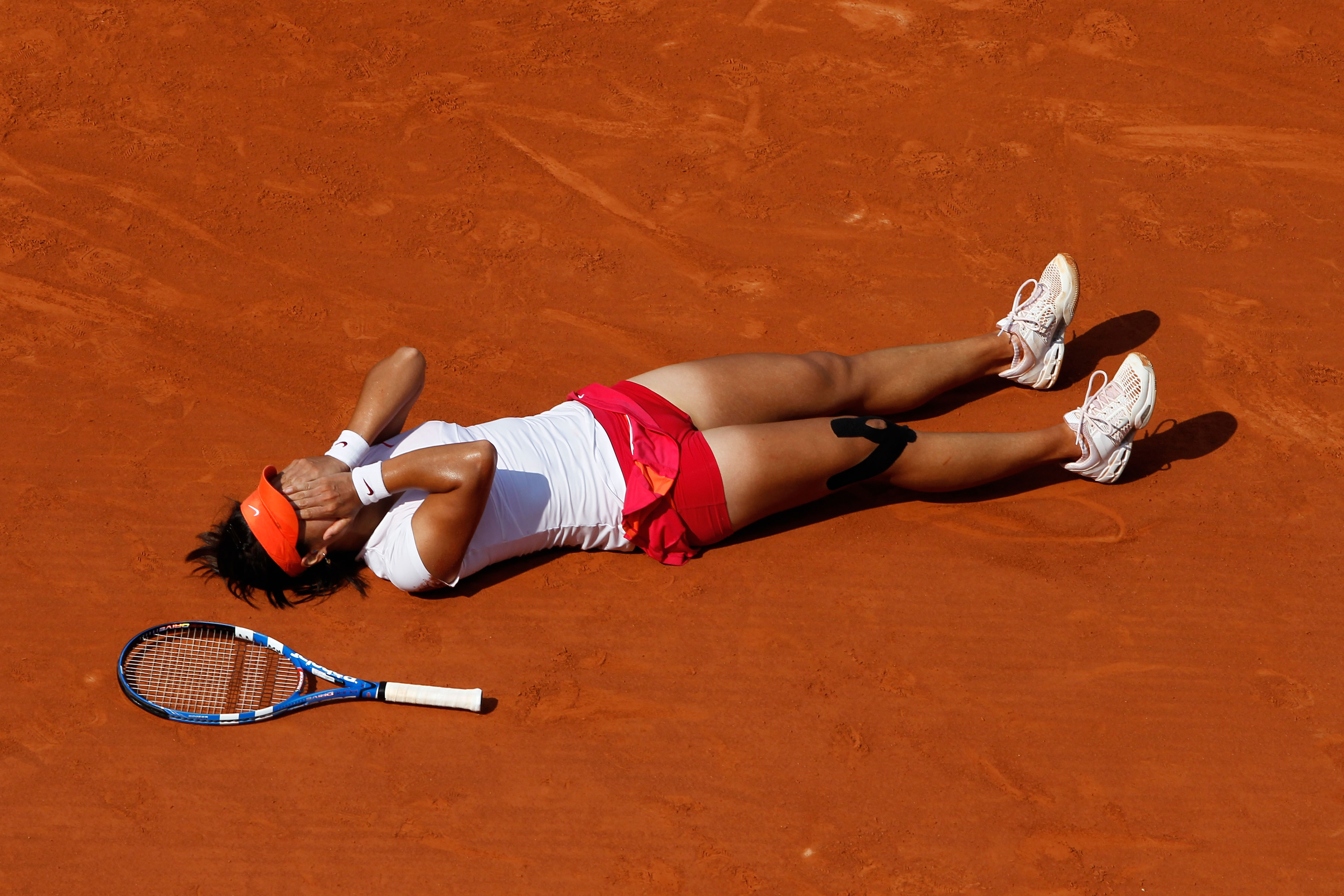 PARIS, FRANCE - JUNE 04:  Na Li of China celebrates matchpoint during the women's singles final match between Francesca Schiavone of Italy and Na Li of China on day fourteen of the French Open at Roland Garros on June 4, 2011 in Paris, France.  (Photo by 