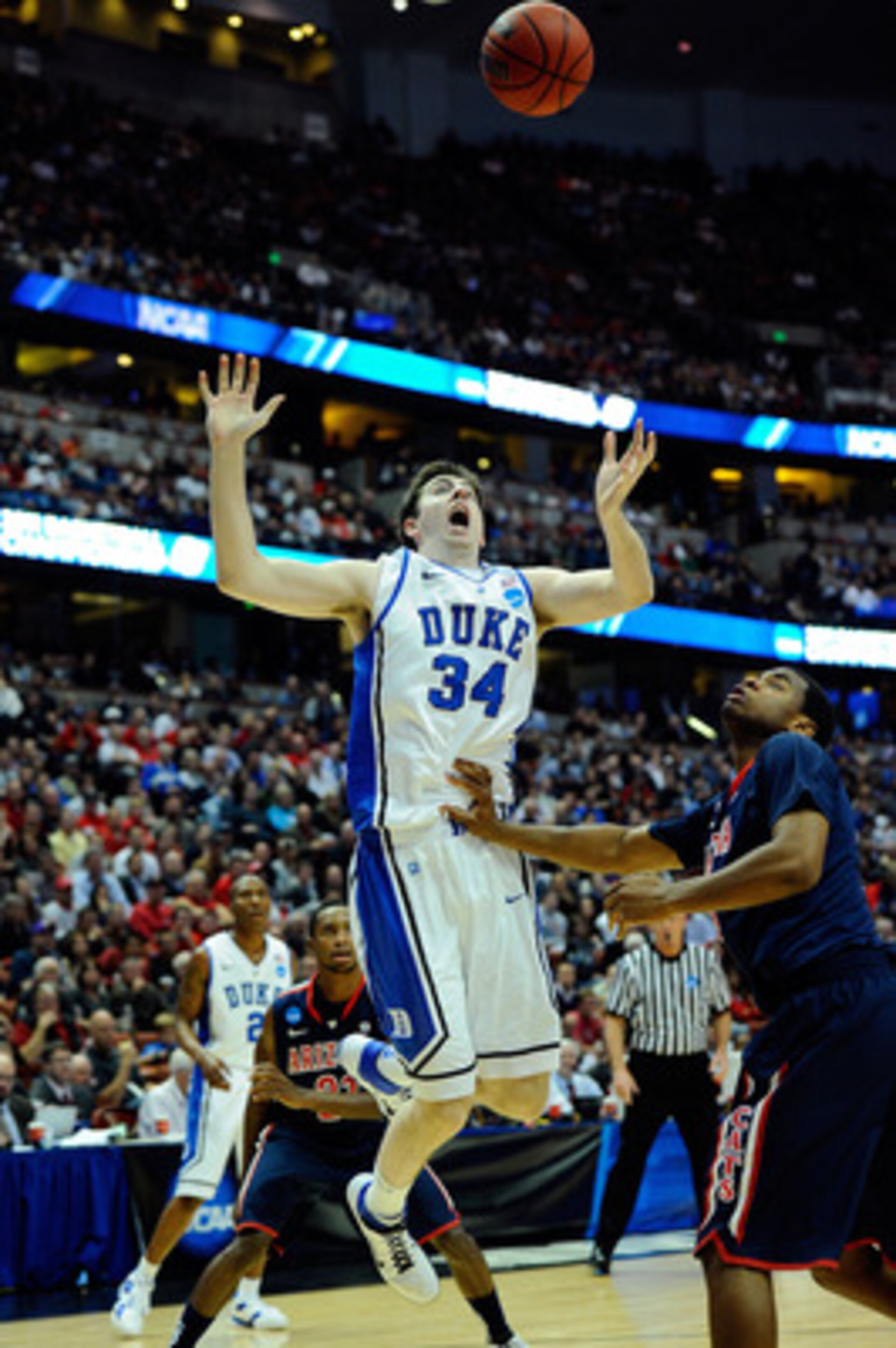 ANAHEIM, CA - MARCH 24:  Ryan Kelly #34 of the Duke Blue Devils looses control against Kevin Parrom #3 of the Arizona Wildcats during the west regional semifinal of the 2011 NCAA men's basketball tournament at the Honda Center on March 24, 2011 in Anaheim