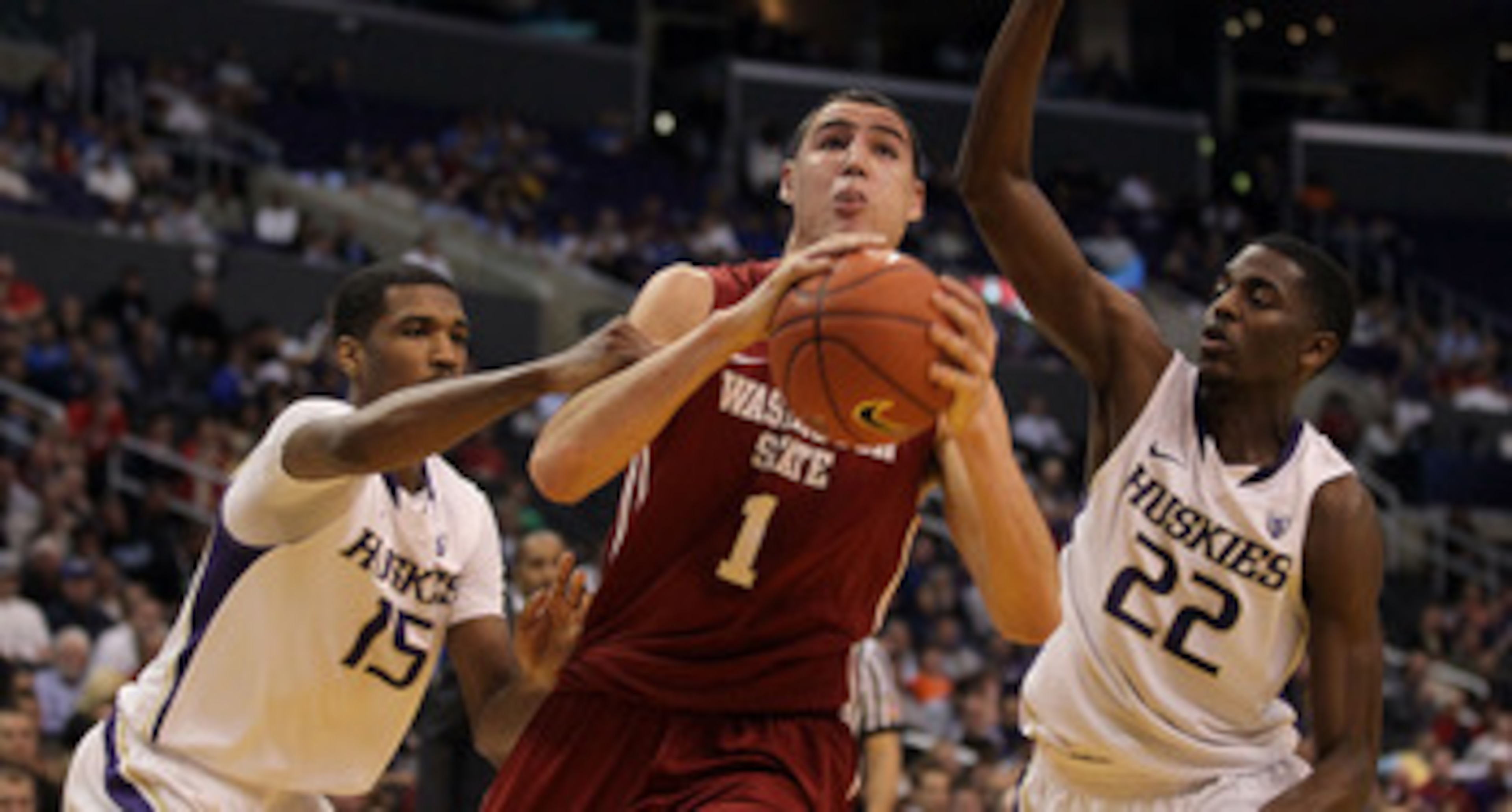 LOS ANGELES, CA - MARCH 10: Klay Thompson #1 of the Washington State Cougars drives between Scott Suggs #15 and Justin Holiday #22 of the Washington Huskies in the first half in the quarterfinals of the 2011 Pacific Life Pac-10 Men's Basketball Tournamen LOS ANGELES, CA - MARCH 10: Klay Thompson #1 of the Washington State Cougars drives between Scott Suggs #15 and Justin Holiday #22 of the Washington Huskies in the first half in the quarterfinals of the 2011 Pacific Life Pac-10 Men's Basketball Tournamen