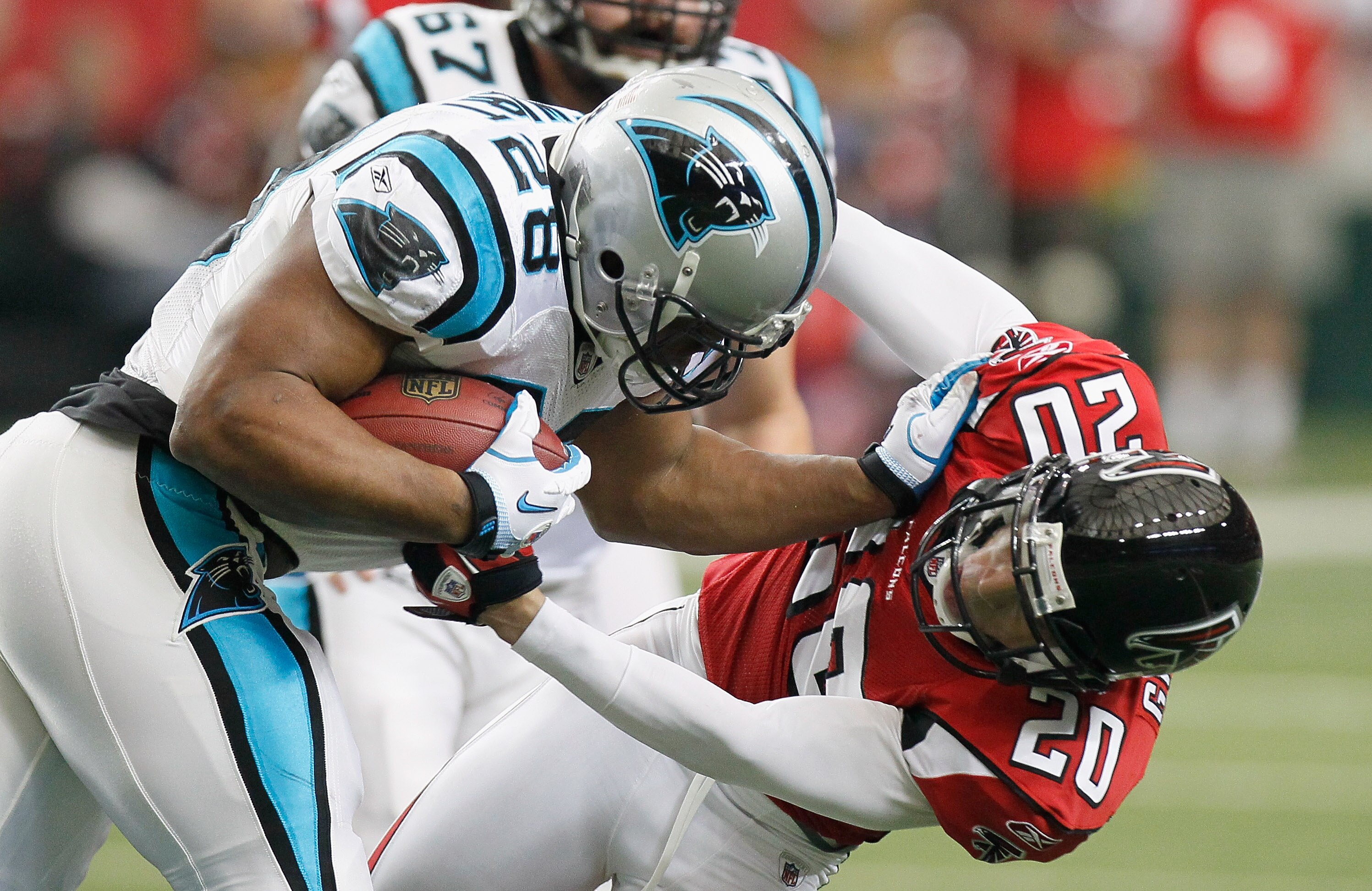 ATLANTA, GA - JANUARY 02:  Jonathan Stewart #28 of the Carolina Panthers stiff arms Brent Grimes #20 of the Atlanta Falcons at Georgia Dome on January 2, 2011 in Atlanta, Georgia.  (Photo by Kevin C. Cox/Getty Images)