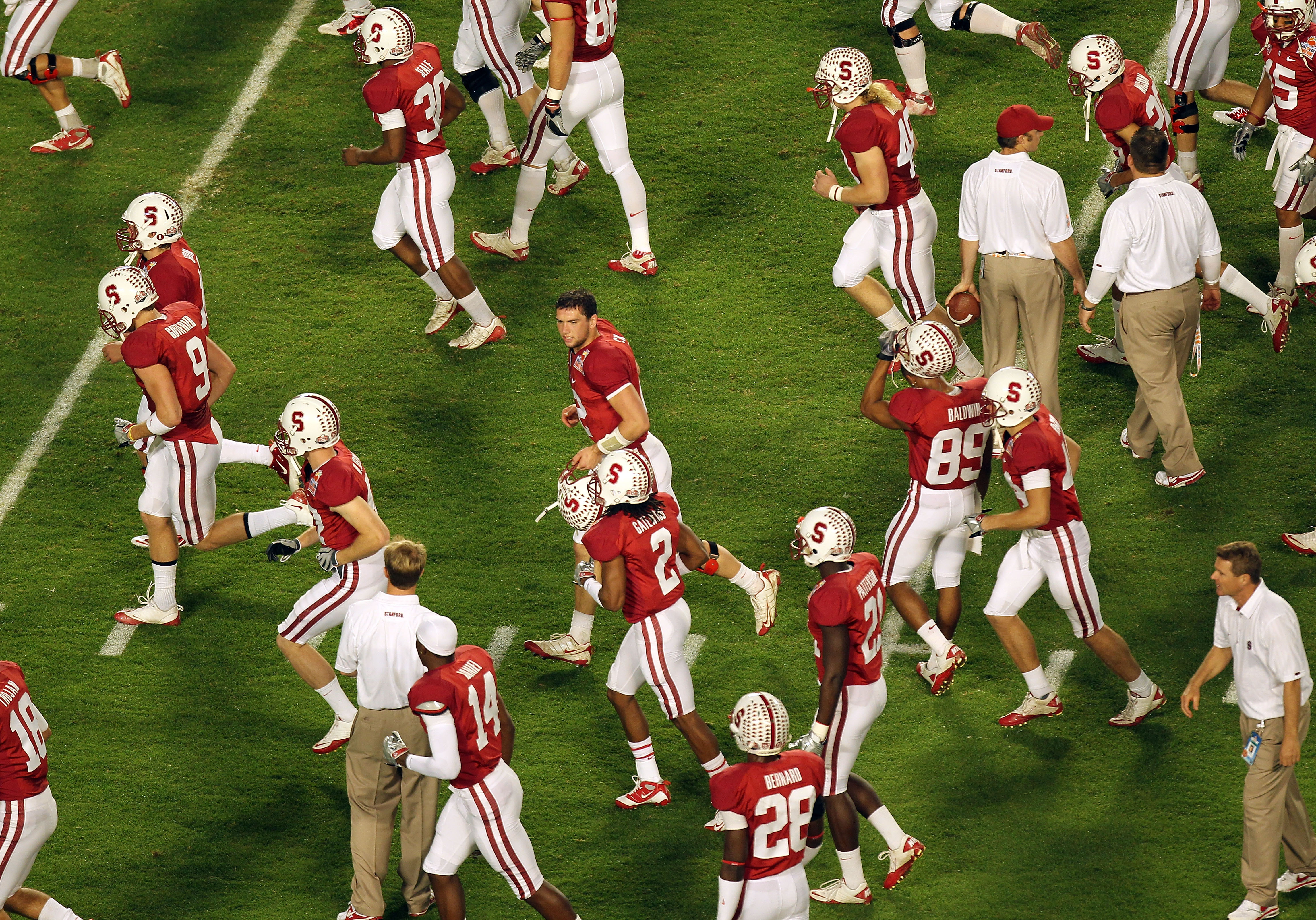 MIAMI, FL - JANUARY 03:  Quarterback Andrew Luck #12 (C with no helmet) of the Stanford Cardinal runs on the field with his teammates against the Virginia Tech Hokies during the 2011 Discover Orange Bowl at Sun Life Stadium on January 3, 2011 in Miami, Fl