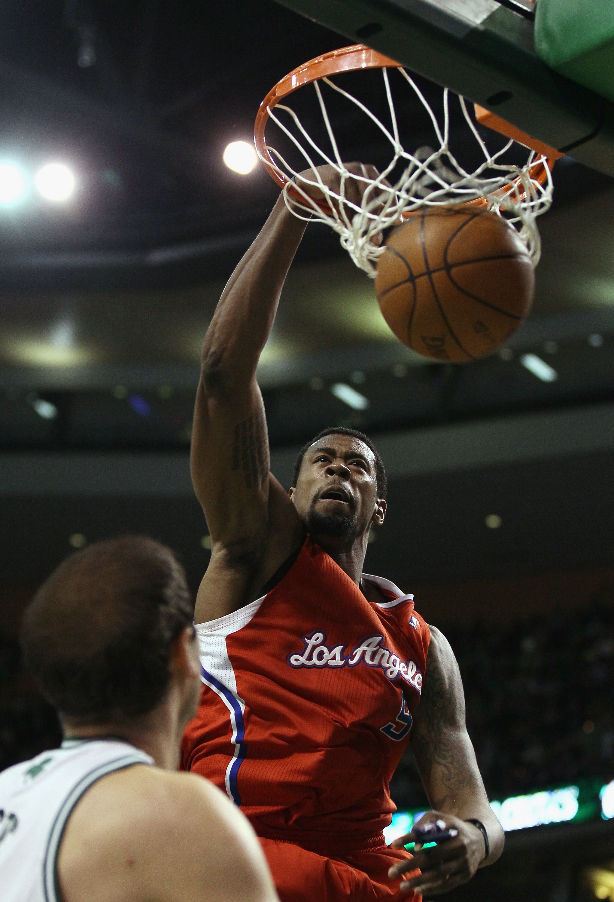 BOSTON, MA - MARCH 09:  DeAndre Jordan #9 of the Los Angeles Clippers dunks the ball as Nenad Krstic #4 of the Boston Celtics defends on March 9, 2011 at the TD Garden in Boston, Massachusetts. The Los Angeles Clippers defeated the Boston Celtics 108-103.
