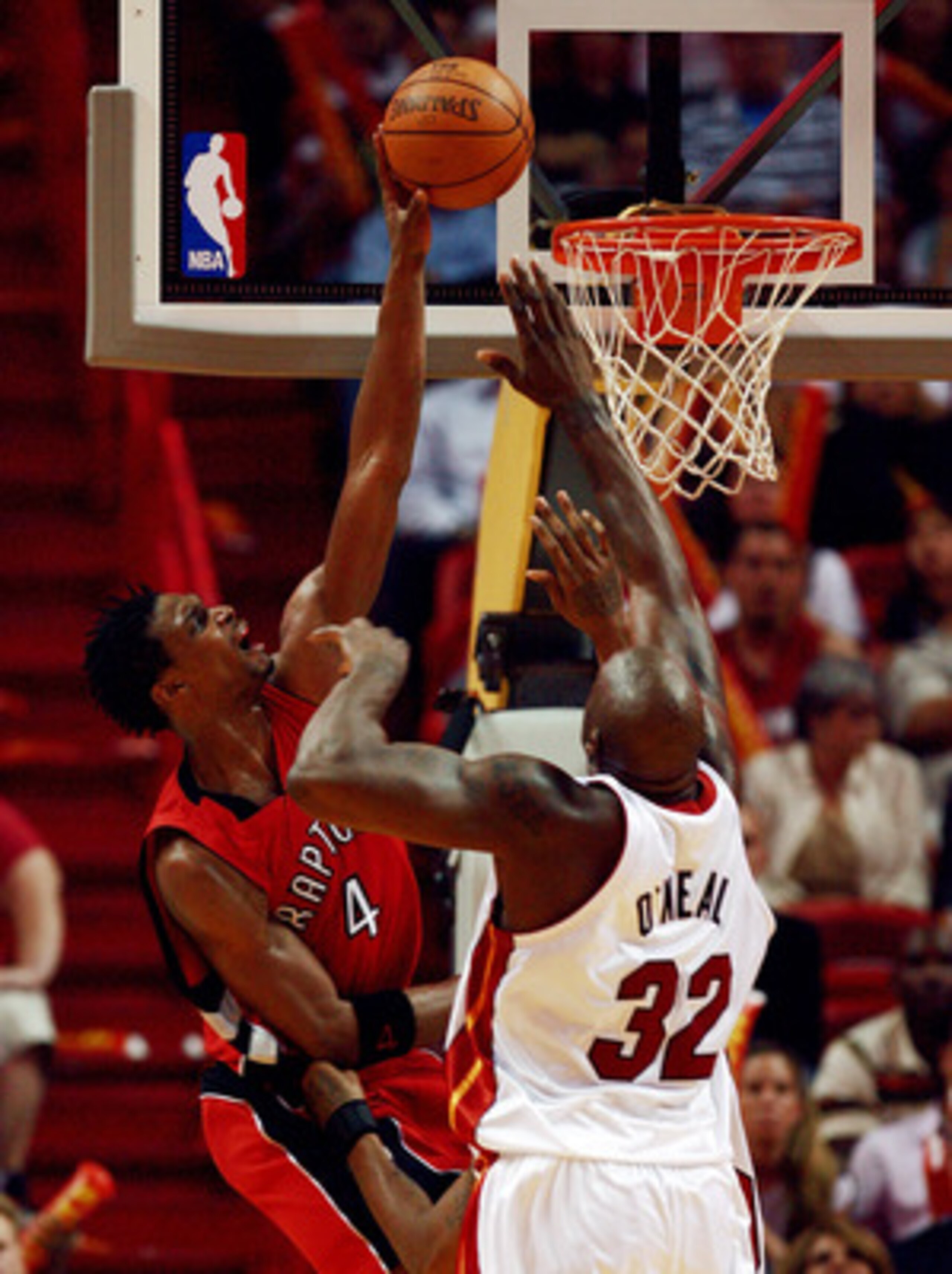 MIAMI - APRIL 03:  Shaquille O'Neal #32 of the Miami Heat tries to stop Chris Bosh #4 of the Toronto Raptors at American Airlines Arena on April 3,  2007 in Miami, Florida. The Heat defeated the Raptors 92-89. NOTE TO USER: User expressly acknowledges and