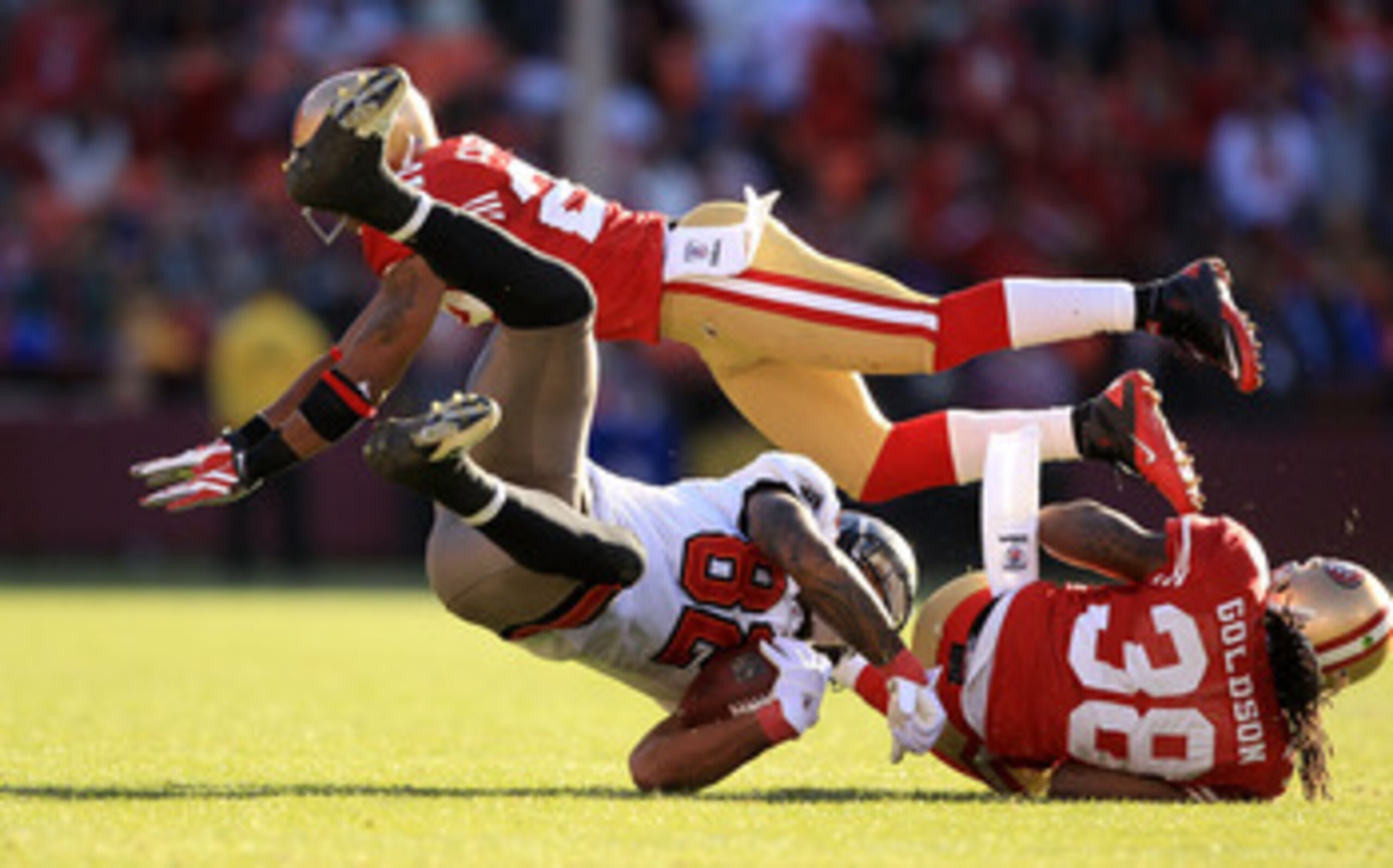 SAN FRANCISCO - NOVEMBER 21: Kellen Winslow #82 of the Tampa Bay Buccaneers is hit by Dashon Goldson #38 and Nate Clements #22 of the San Francisco 49ers at Candlestick Park on November 21, 2010 in San Francisco, California.  (Photo by Ezra Shaw/Getty Ima