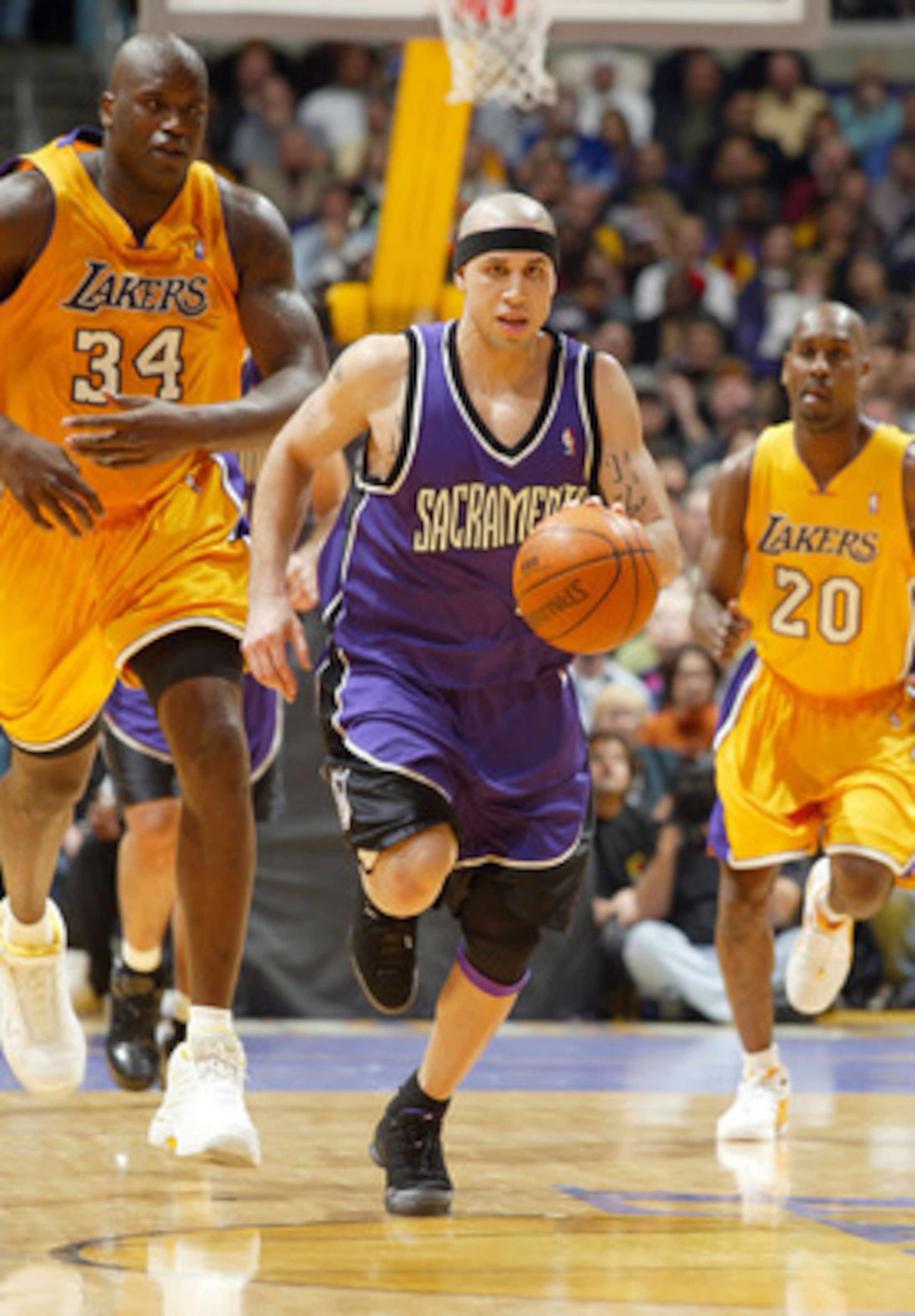 LOS ANGELES - FEBRUARY 26:  Mike Bibby #10 of the Sacramento Kings drives up court past Shaquille O'Neal #34 and Gary Payton #20 of the Los Angeles Lakers at Staples Center on February 26, 2004 in Los Angeles, California.  NOTE TO USER: User expressly ack