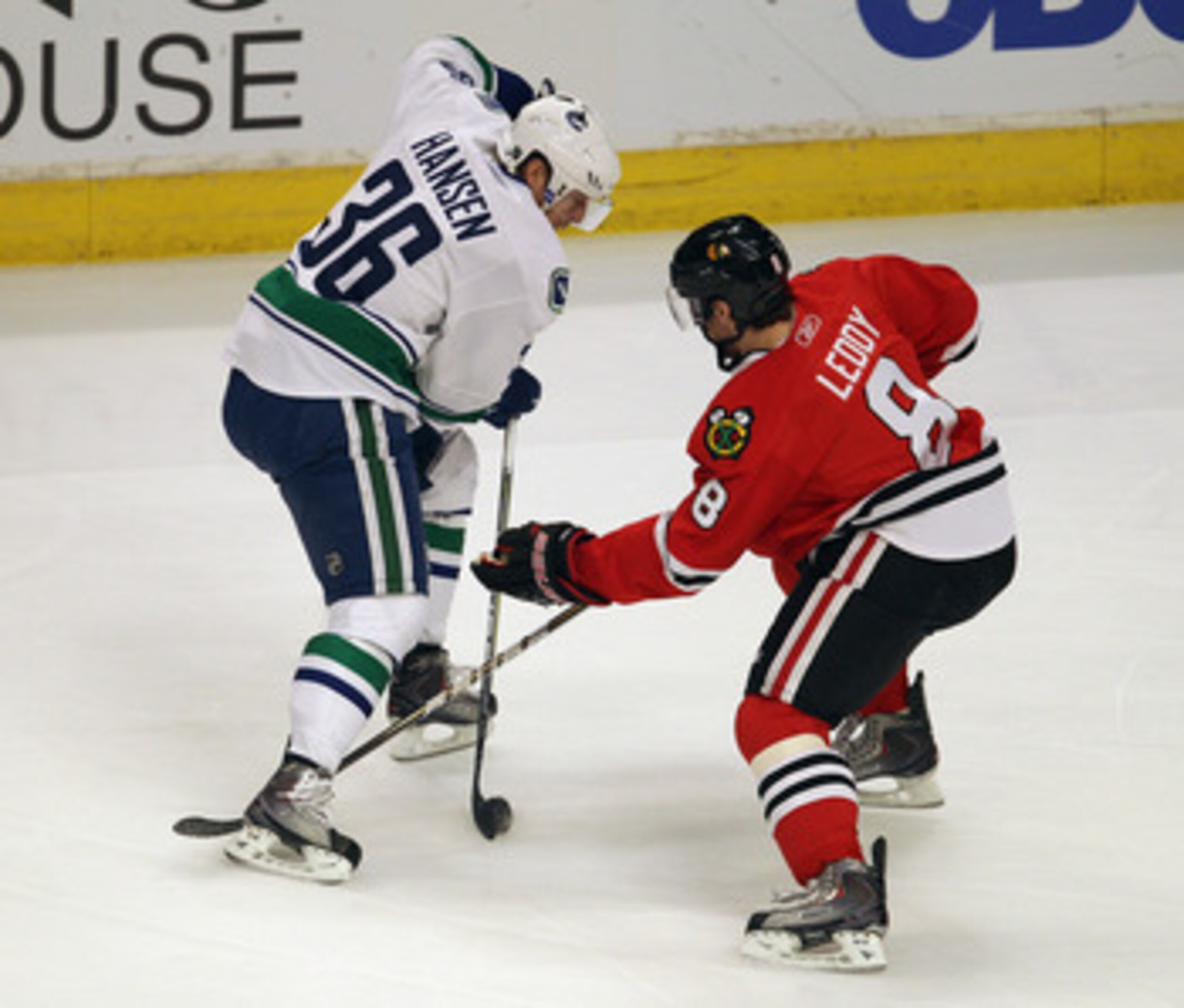 CHICAGO, IL - APRIL 19: Jannik Hansen #36 of the Vancouver Canucks controls the puck under pressure from Nick Leddy #8 of the Chicago Blackhawks in Game Four of the Western Conference Quarterfinals during the 2011 NHL Stanley Cup Playoffs at the United Ce