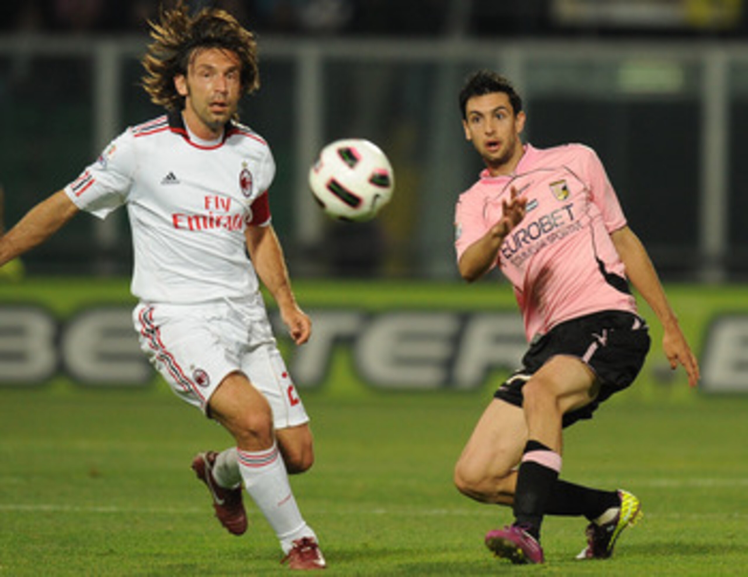 PALERMO, ITALY - MAY 10:  Javier Pastore (R) of Palermo and Andrea Pirlo of Palermo compete for the ball during the Tim Cup between US Citta di Palermo and AC Milan at Stadio Renzo Barbera on May 10, 2011 in Palermo, Italy.  (Photo by Tullio M. Puglia/Get