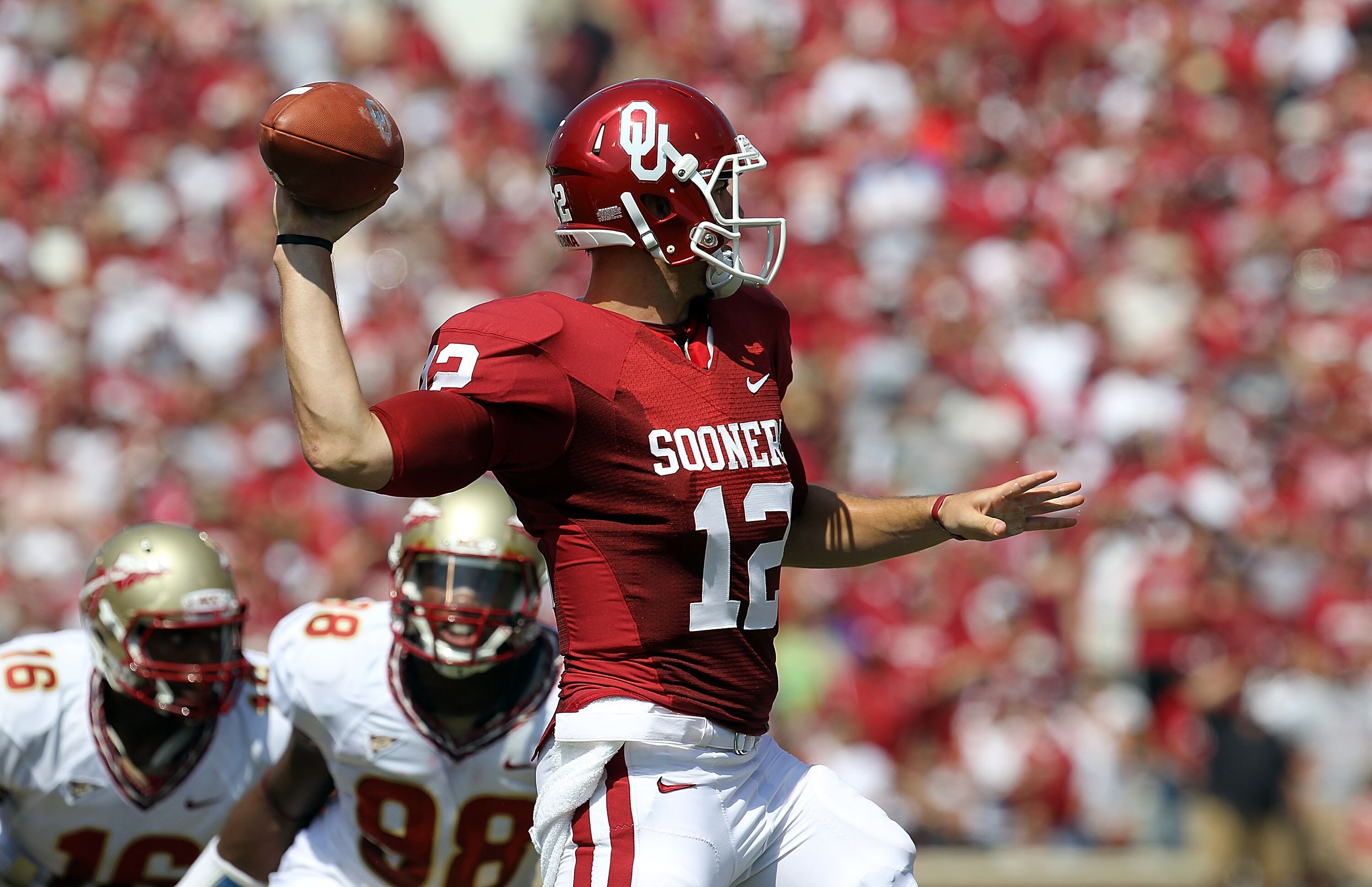 NORMAN, OK - SEPTEMBER 11:  Quarterback Landry Jones #12 of the Oklahoma Sooners drops back to pass against the Florida State Seminoles in the first quarter at Gaylord Family Oklahoma Memorial Stadium on September 11, 2010 in Norman, Oklahoma.  (Photo by