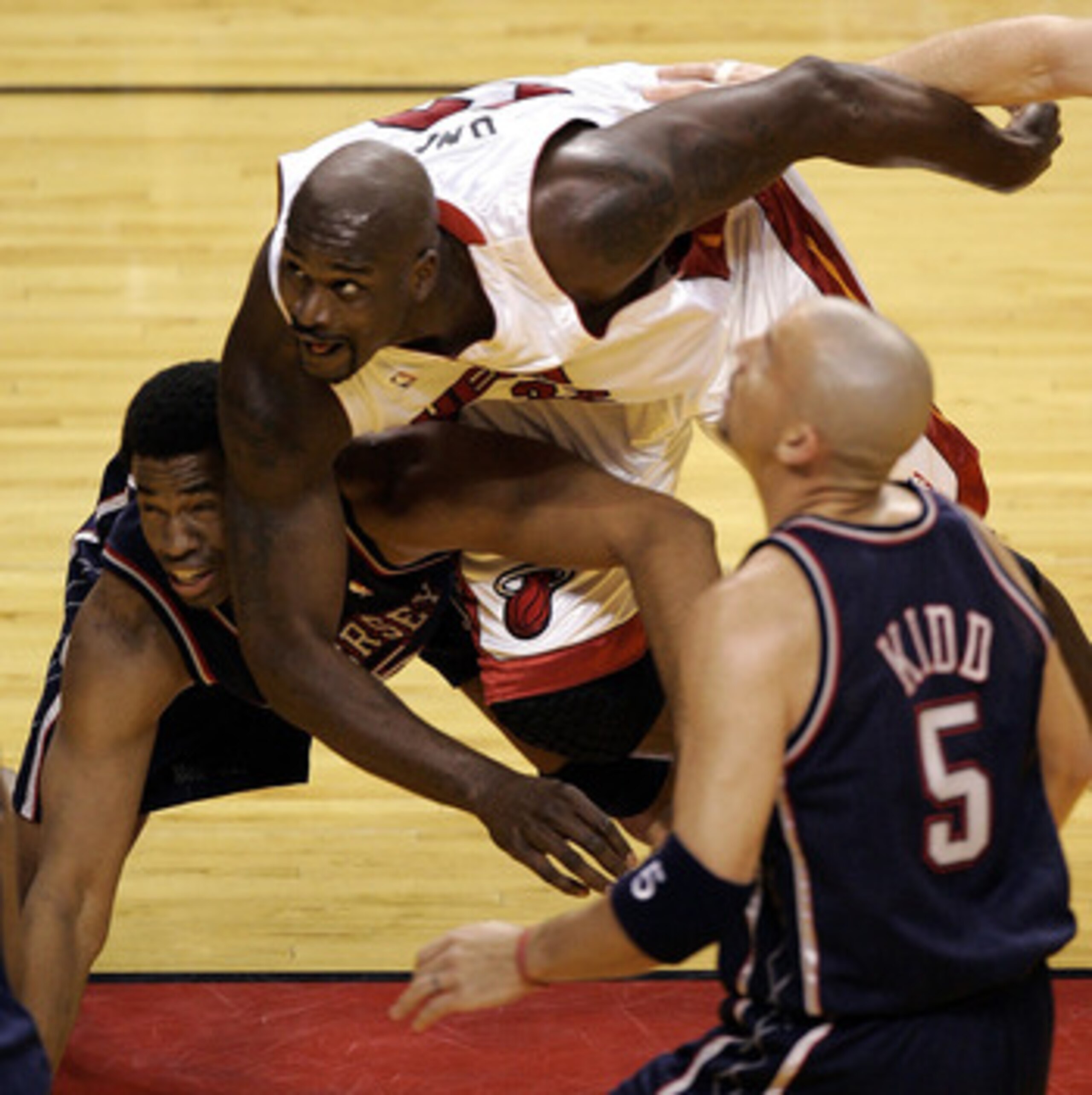 MIAMI - APRIL 24:  Shaquille O'Neal #32 of the Miami Heat tangles with Jason Collins #35 of the New Jersey Nets in Game one of the Eastern Conference Quarterfinals during the 2005 NBA Playoffs on April 24, 2005 at the American Airlines Arena in Miami, Flo