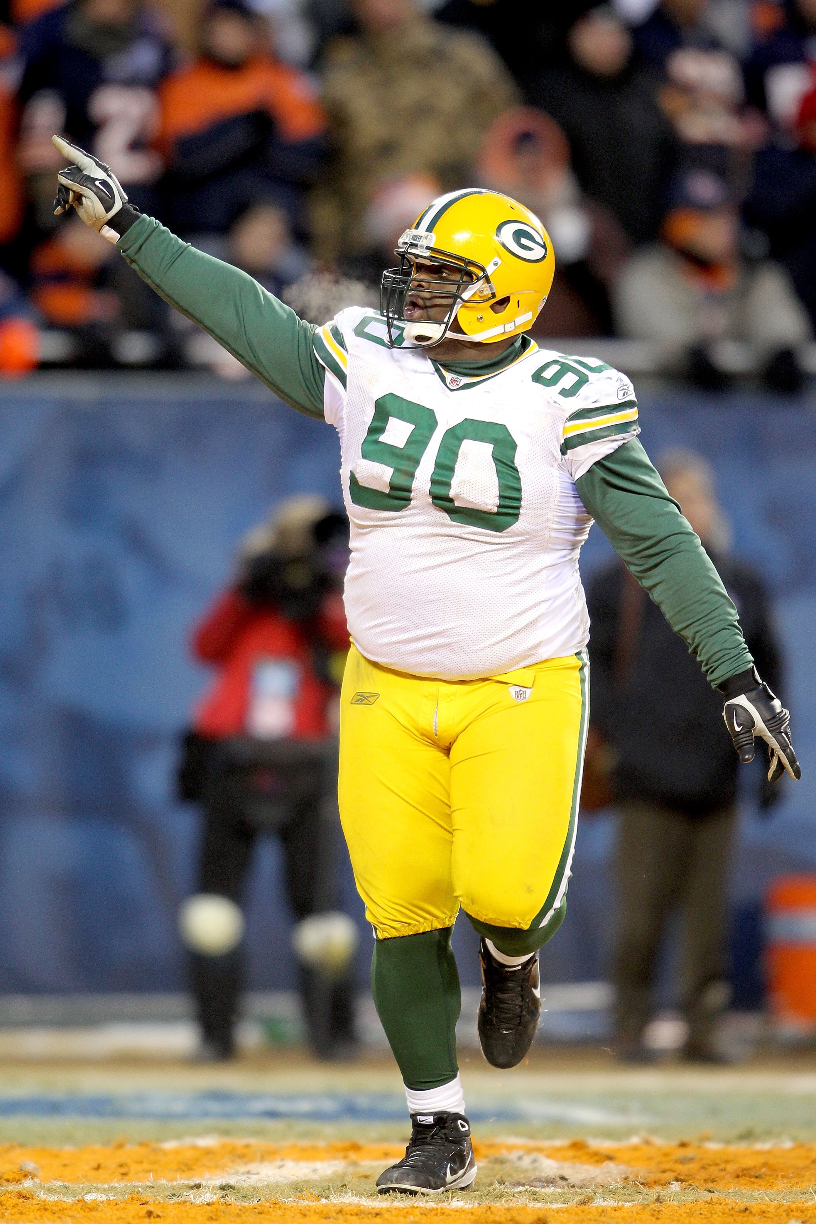 CHICAGO, IL - JANUARY 23:  B.J. Raji #90 of the Green Bay Packers reacts after scoring on a 18-yard interception return for a touchdown in the fourth quarter against the Chicago Bears in the NFC Championship Game at Soldier Field on January 23, 2011 in Ch