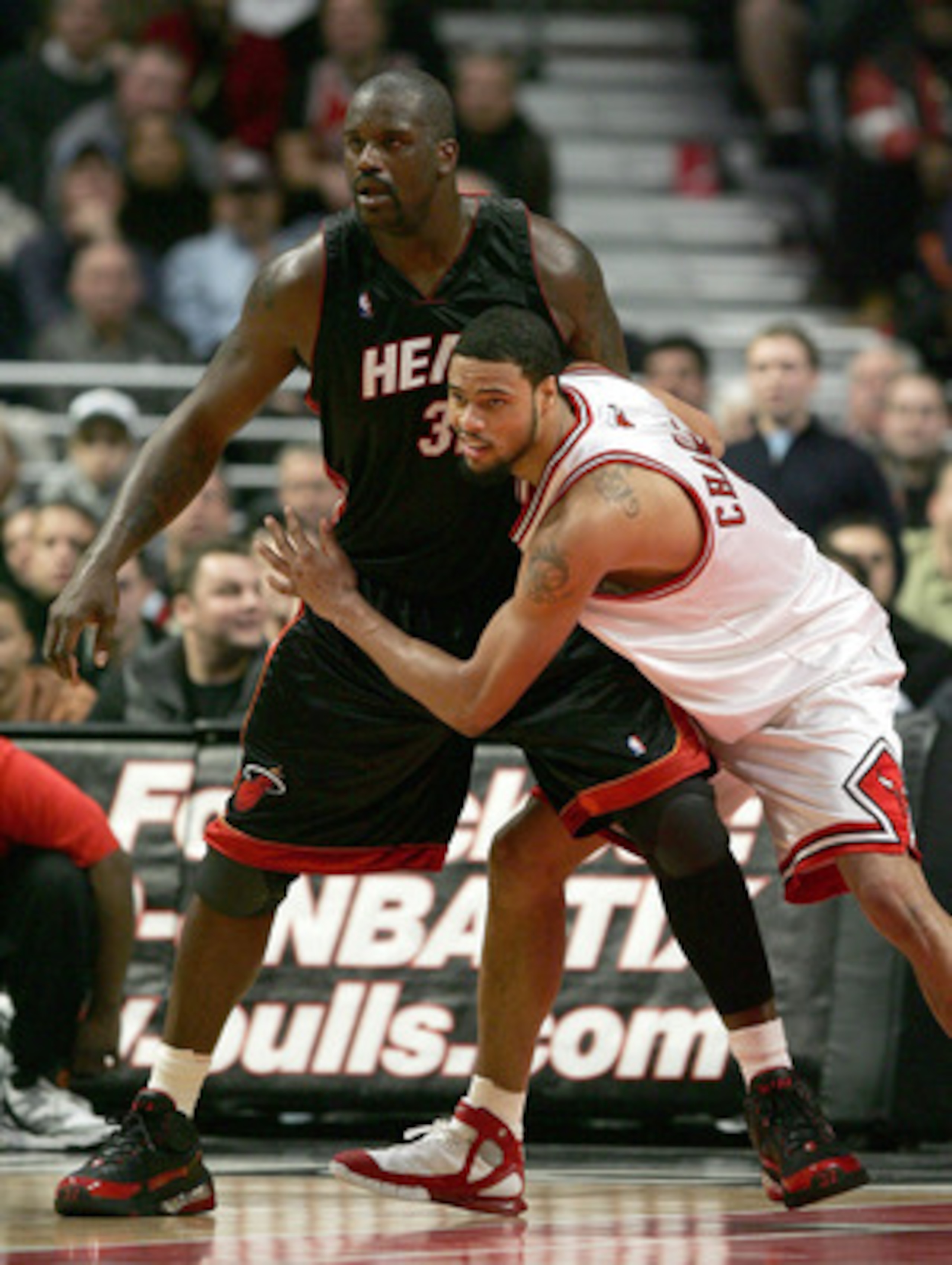 CHICAGO - DECEMBER 13:  Tyson Chandler #3 of the Chicago Bulls tries to defend against Shaquille O'Neal #32 of the Miami Heat on December 13, 2005 at the United Center in Chicago, Illinois. The Heat defeated the Bulls 100-97.  NOTE TO USER: User expressly