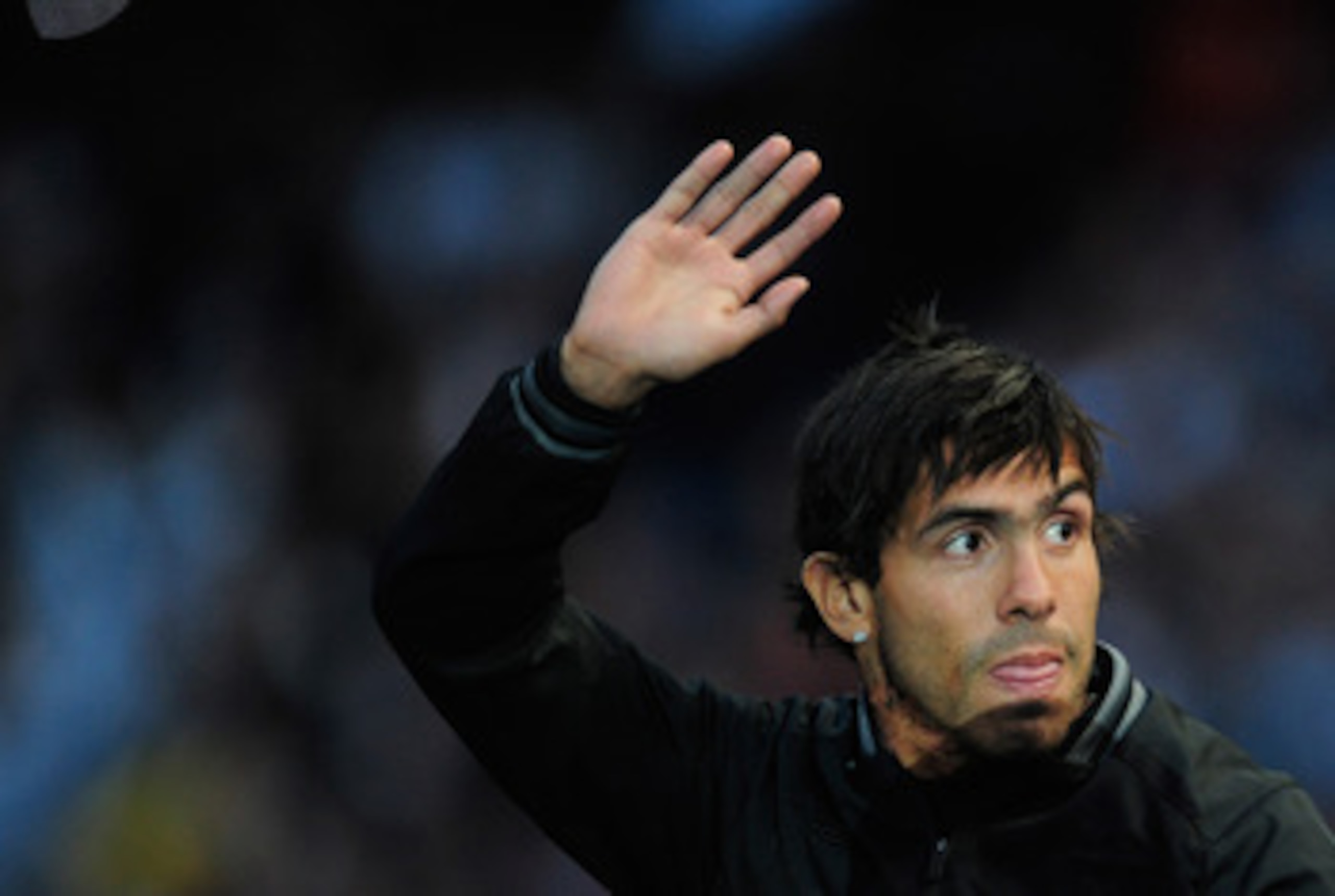 MANCHESTER, ENGLAND - MAY 23:  Carlos Tevez of Manchester City waves to the fans during the Manchester City FA Cup Winners Parade at the City of Manchester stadium on May 23, 2011 in Manchester, United Kingdom.  (Photo by Jamie McDonald/Getty Images)