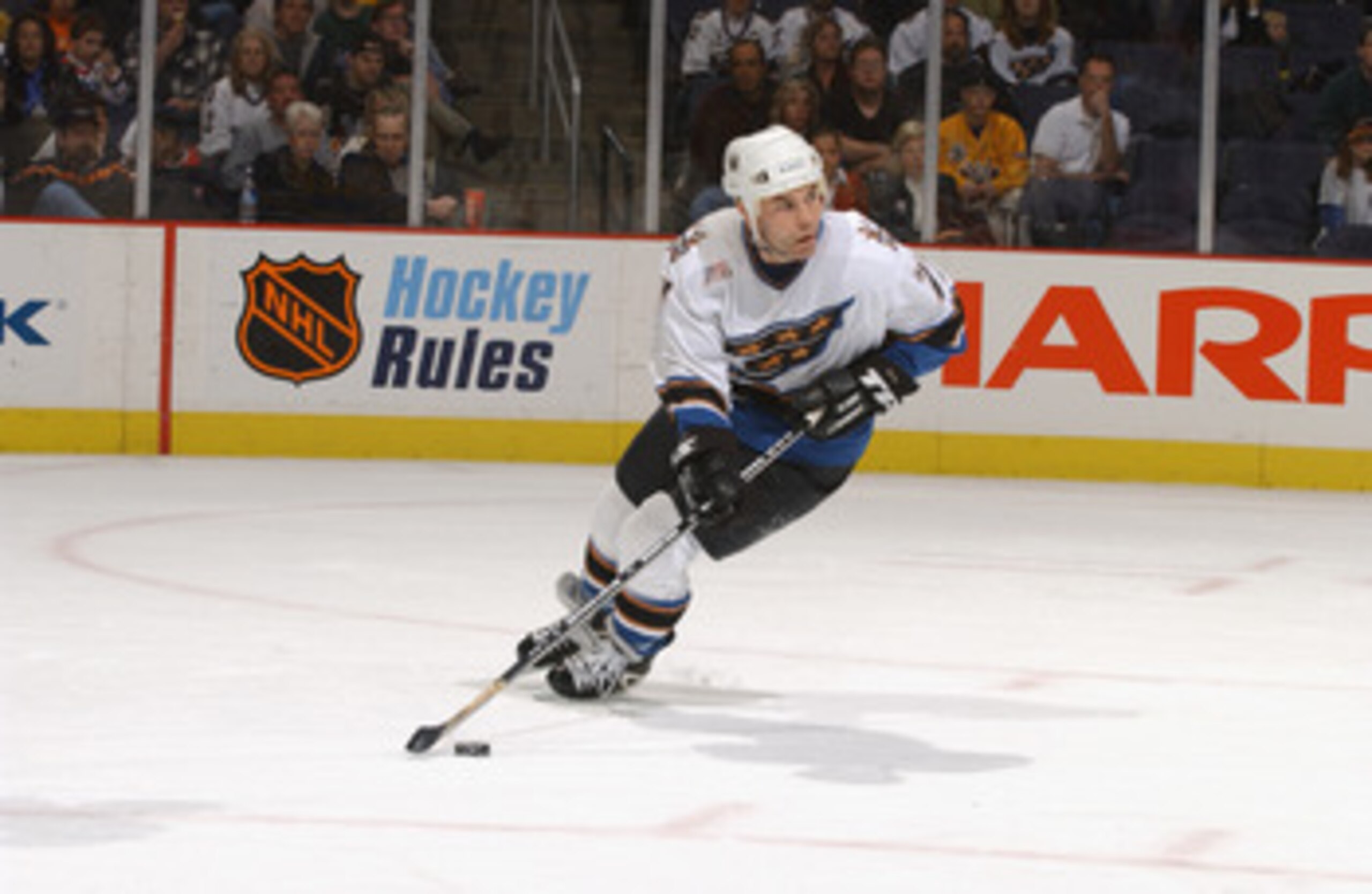 WASHINGTON D.C. - MARCH 10:  Centre Adam Oates #77 of the Washington Capitals skates with the puck during the NHL game against the Edmonton Oilers at the MCI Center in Washington D.C. on March 10, 2002. The Capitals won 4-2. (Photo by Mitchell Layton /Get