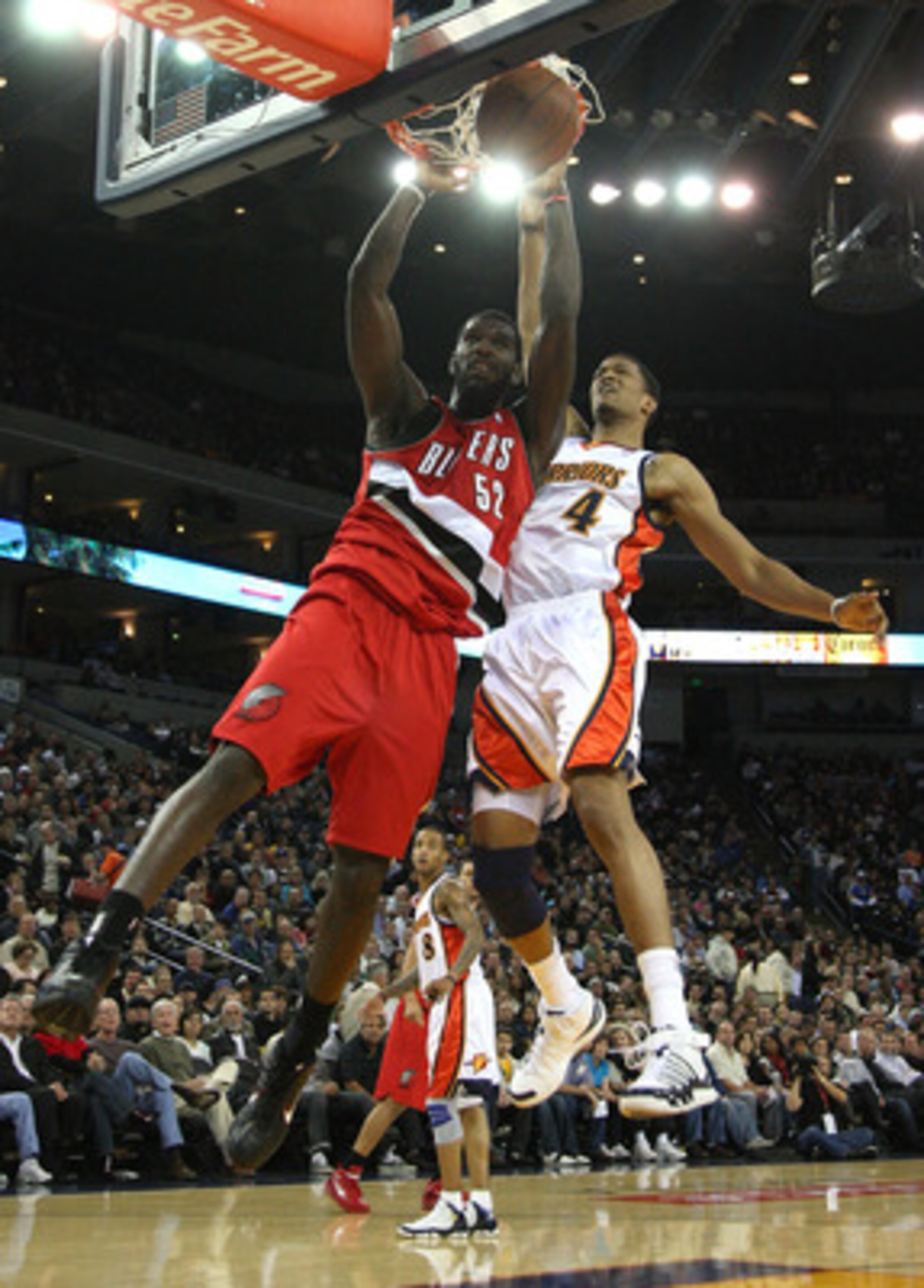OAKLAND, CA - NOVEMBER 20:  Greg Oden #52 of the Portland Trail Blazers dunks over Anthony Randolph #4 of the Golden State Warriors during an NBA game at Oracle Arena on November 20, 2009 in Oakland, California. (Photo by Jed Jacobsohn/Getty Images)