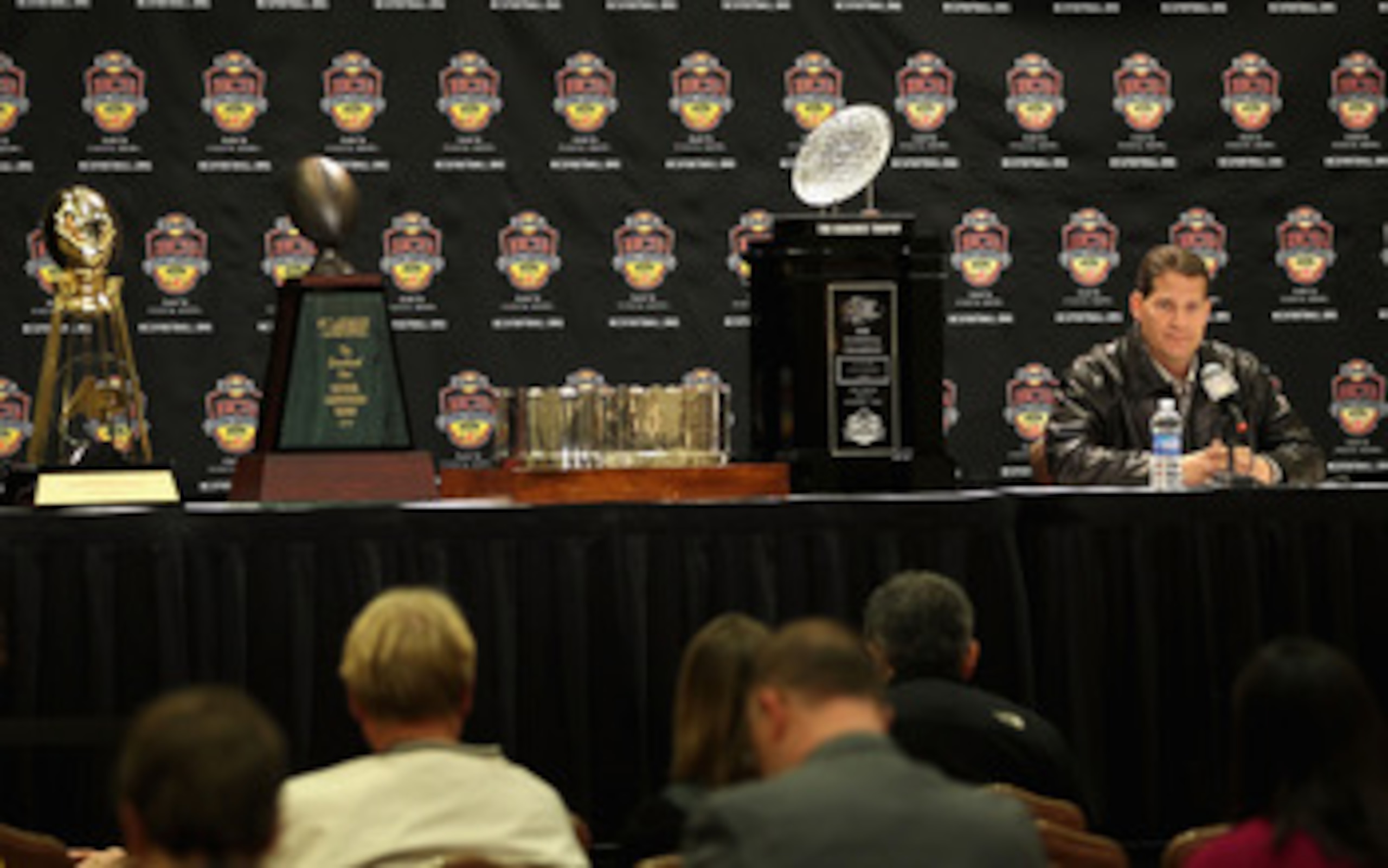 SCOTTSDALE, AZ - JANUARY 11:  Head coach Gene Chizik of the Auburn Tigers sits with the (L-R) Associated Press, Football Writers of America, MacArthur Bowl and the Coaches trophys during a press conference for the Tostitos BCS National Championship Game a