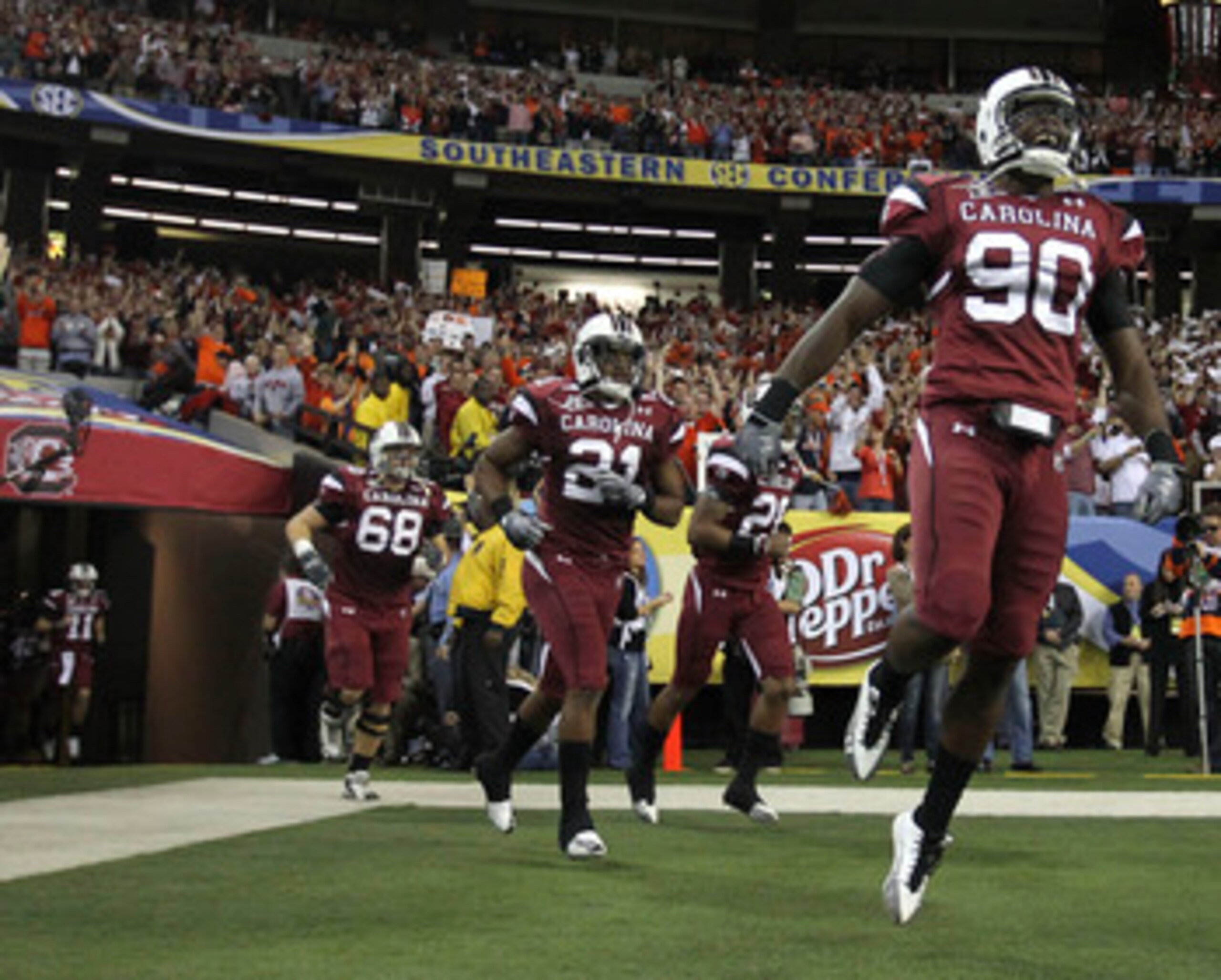 ATLANTA - DECEMBER 4:  Members of the South Carolina Gamecocks run out of the tunnel before the 2010 SEC Championship against the Auburn Tigers at Georgia Dome on December 4, 2010 in Atlanta, Georgia. (Photo by Mike Zarrilli/Getty Images)