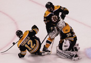 BOSTON, MA - MAY 27:  Tomas Kaberle #12, Adam McQuaid #54 and Tim Thomas #30 of the Boston Bruins defend in Game Seven of the Eastern Conference Finals against the Tampa Bay Lightning during the 2011 NHL Stanley Cup Playoffs at TD Garden on May 27, 2011 i