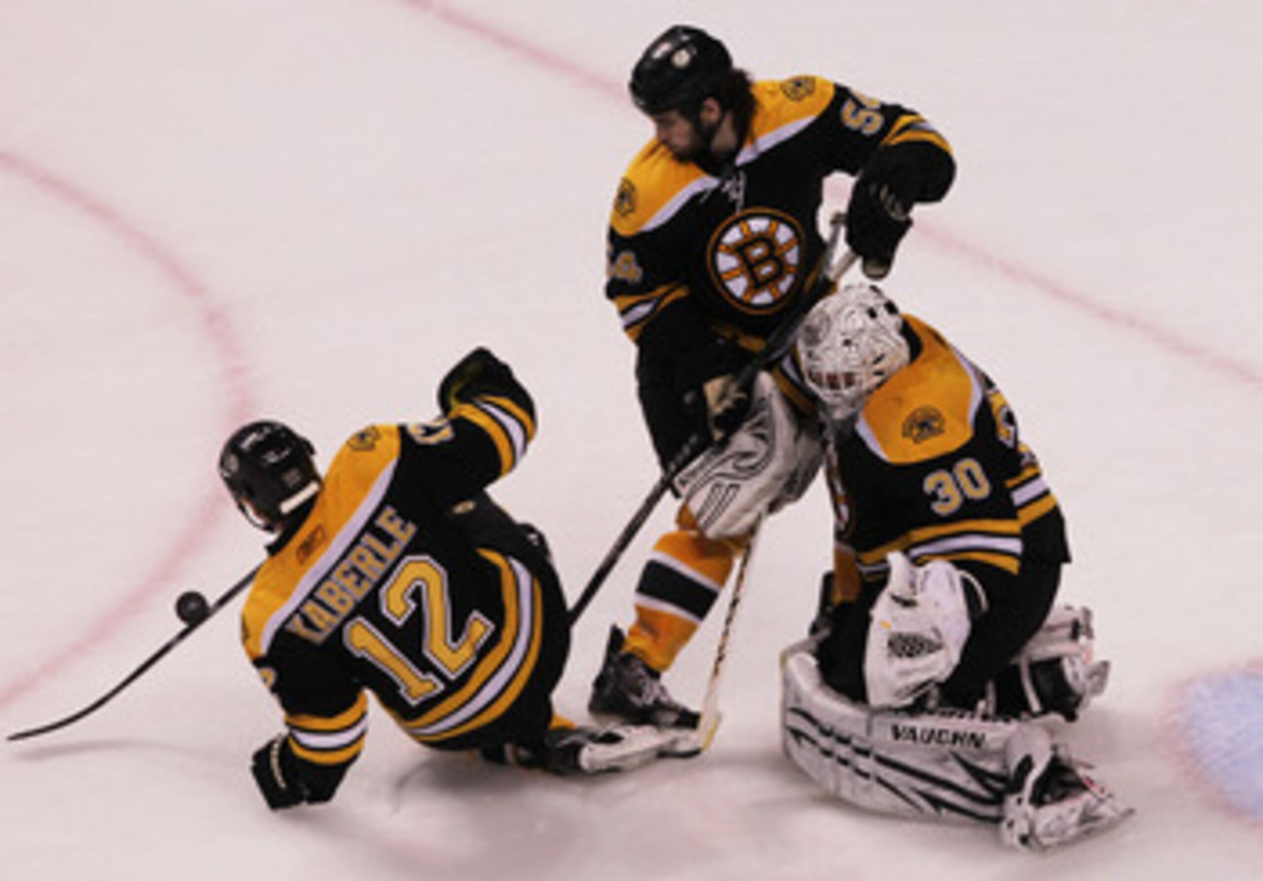 BOSTON, MA - MAY 27:  Tomas Kaberle #12, Adam McQuaid #54 and Tim Thomas #30 of the Boston Bruins defend in Game Seven of the Eastern Conference Finals against the Tampa Bay Lightning during the 2011 NHL Stanley Cup Playoffs at TD Garden on May 27, 2011 i