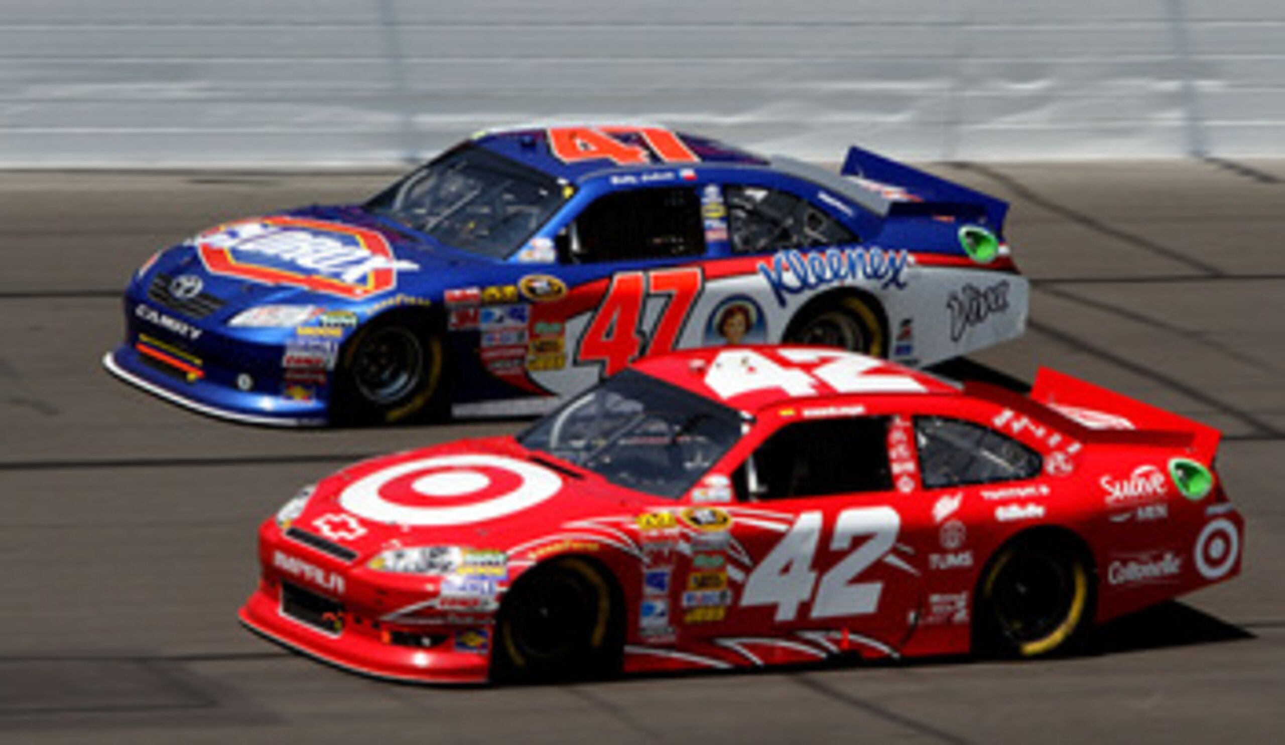 KANSAS CITY, KS - JUNE 05:  Juan Pablo Montoya, driver of the #42 Target Chevrolet, races Bobby Labonte, driver of the #47 Clorox/Kleenex Toyota, during the NASCAR Sprint Cup Series STP 400 at Kansas Speedway on June 5, 2011 in Kansas City, Kansas.  (Phot