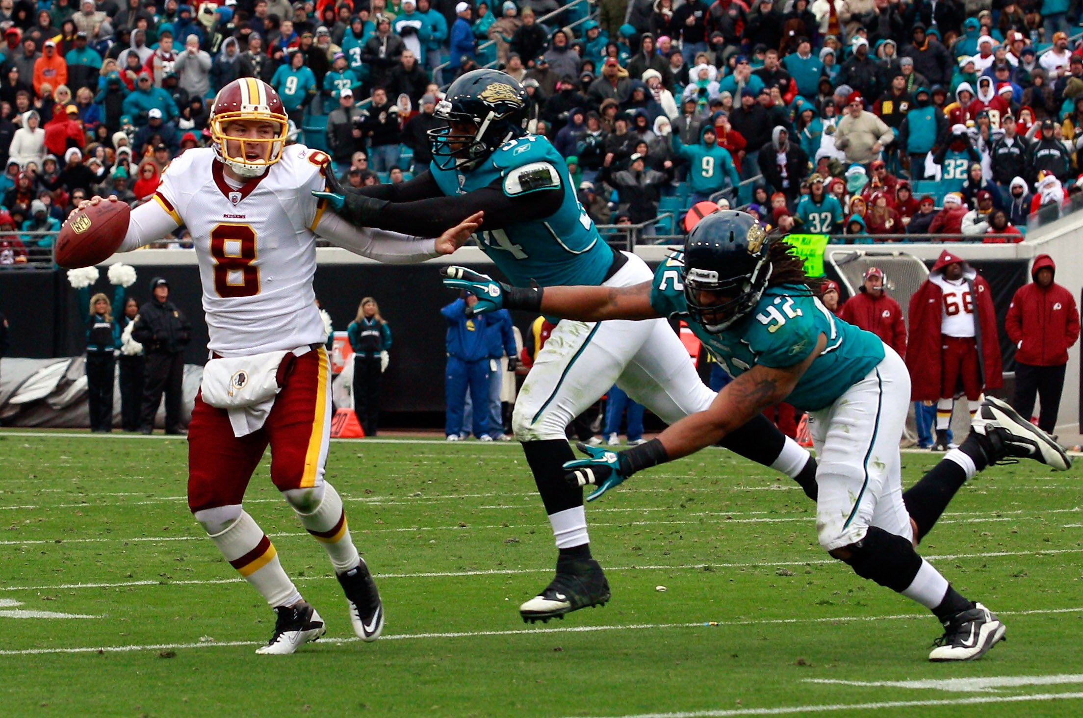 JACKSONVILLE, FL - DECEMBER 26: Quarterback Rex Grossman #8 of the Washington Redskins is pressured by Austen Lane #92 and Jeremy Mincey #94 of the Jacksonville Jaguars during the game at EverBank Field on December 26, 2010 in Jacksonville, Florida.  (Pho