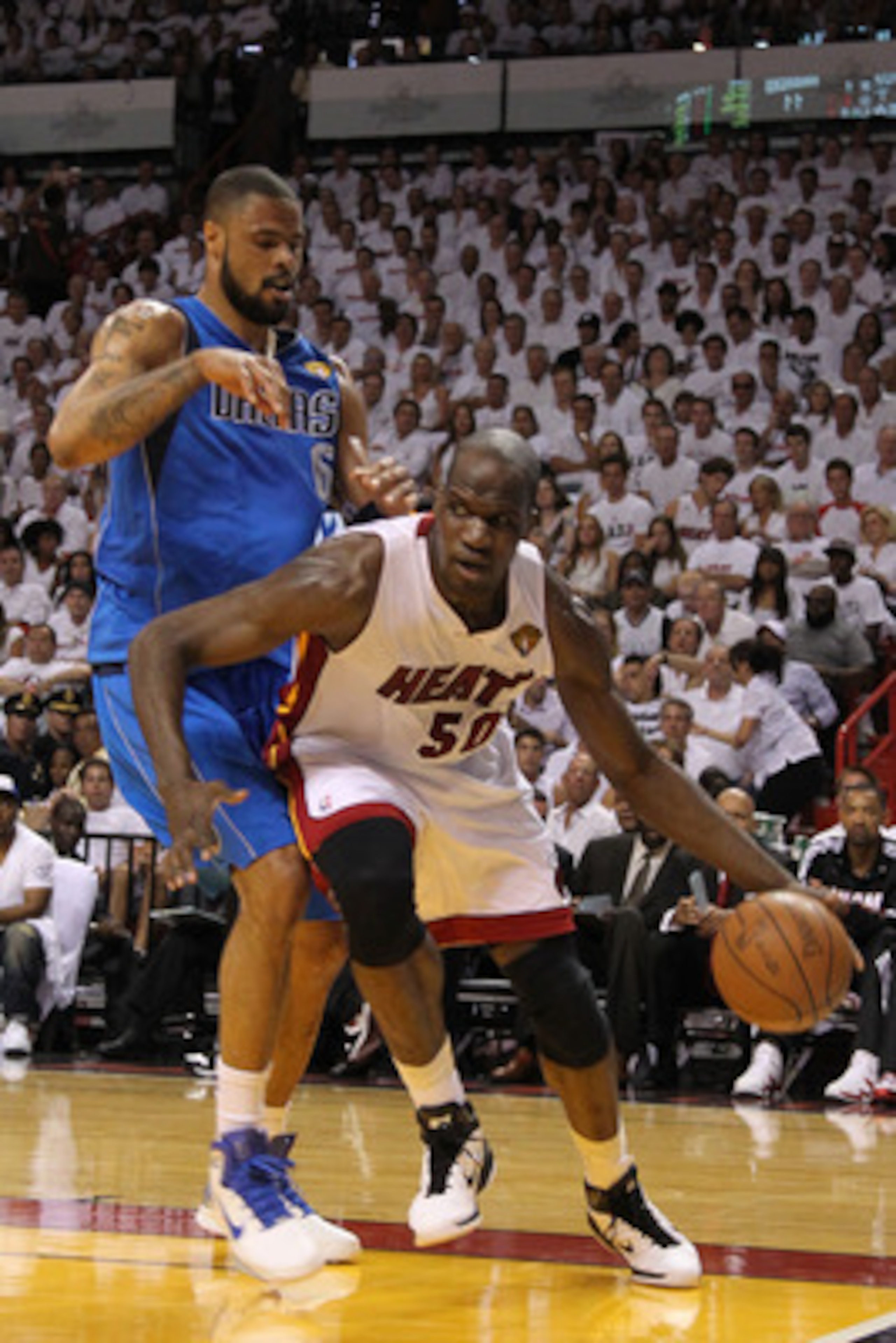 MIAMI, FL - MAY 31:  Joel Anthony #50 of the Miami Heat drives against Tyson Chandler #6 of the Dallas Mavericks in Game One of the 2011 NBA Finals at American Airlines Arena on May 31, 2011 in Miami, Florida. NOTE TO USER: User expressly acknowledges and