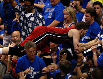 DALLAS, TX - JUNE 05:  Mike Miller #13 of the Miami Heat falls into the stands behind the basket in the second half while taking on the Dallas Mavericks in Game Three of the 2011 NBA Finals at American Airlines Center on June 5, 2011 in Dallas, Texas.  NO