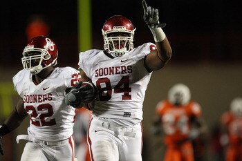 STILLWATER, OK - NOVEMBER 29:  Defensive end Frank Alexander #84 of the Oklahoma Sooners runs for a defensive two-point conversion with Keenan Clayton #22 against the Oklahoma State Cowboys at Boone Pickens Stadium on November 29, 2008 in Stillwater, Okla