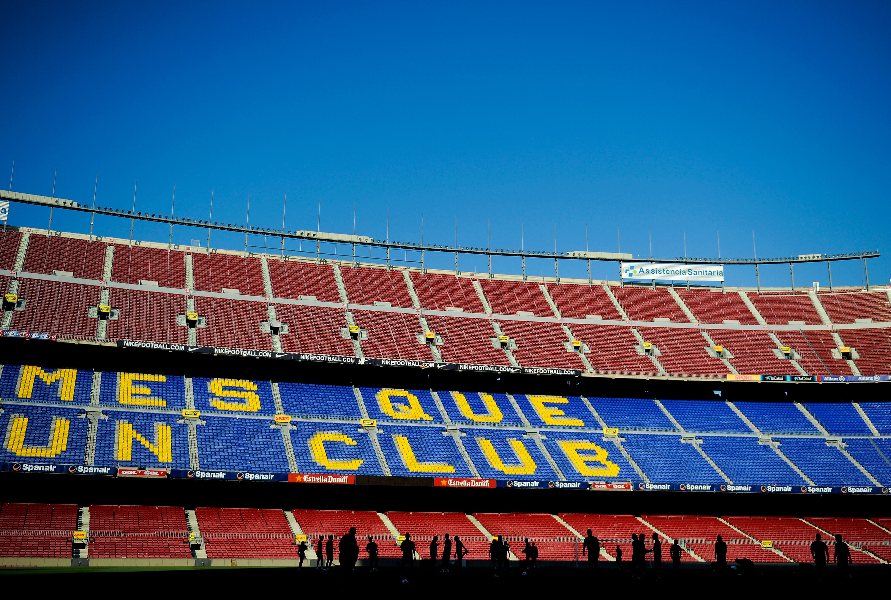 BARCELONA, SPAIN - MAY 23: FC Barcelona players are seen silhouetted underneath their slogan 'More than a club' during the FC Barcelona training session held ahead of next saturday UEFA Champions League Final at the Camp Nou Stadium on May 23, 2011 in Bar