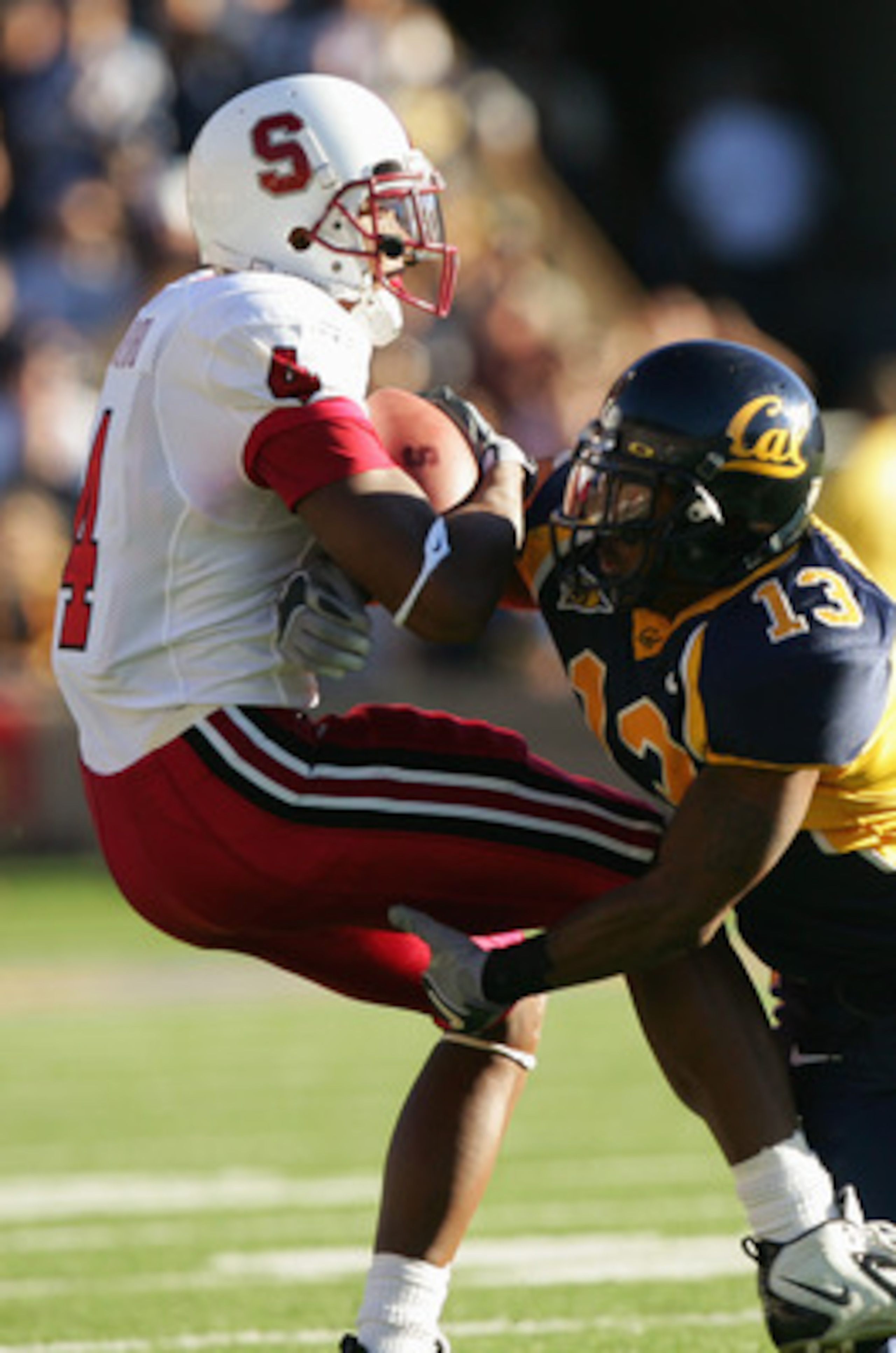 BERKELEY, CA - NOVEMBER 20: Wide receiver Mark Bradford #4 of the Stanford University Cardinal is tackled by cornerback Daymeion Hughes #13 of the University of California, Berkeley Golden Bears during the game at Memorial Stadium on November 20, 2004 in BERKELEY, CA - NOVEMBER 20: Wide receiver Mark Bradford #4 of the Stanford University Cardinal is tackled by cornerback Daymeion Hughes #13 of the University of California, Berkeley Golden Bears during the game at Memorial Stadium on November 20, 2004 in