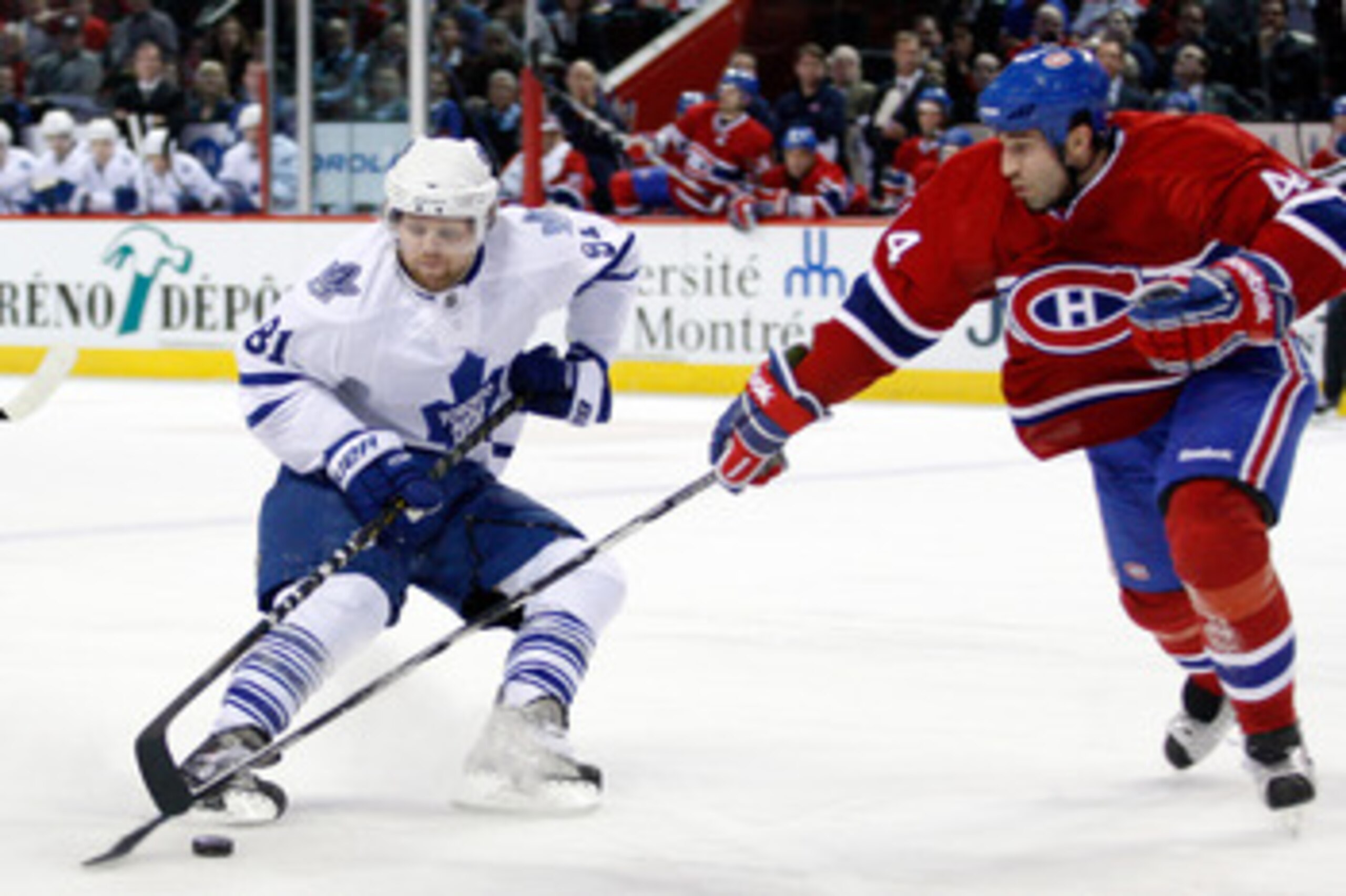 MONTREAL, CANADA - FEBRUARY 24:  Phil Kessel #81 of the Toronto Maple Leafs slides the puck past Roman Hamrlik #44 of the Montreal Canadiens during the NHL game at the Bell Centre on February 24, 2011 in Montreal, Quebec, Canada.  The Maple Leafs defeated