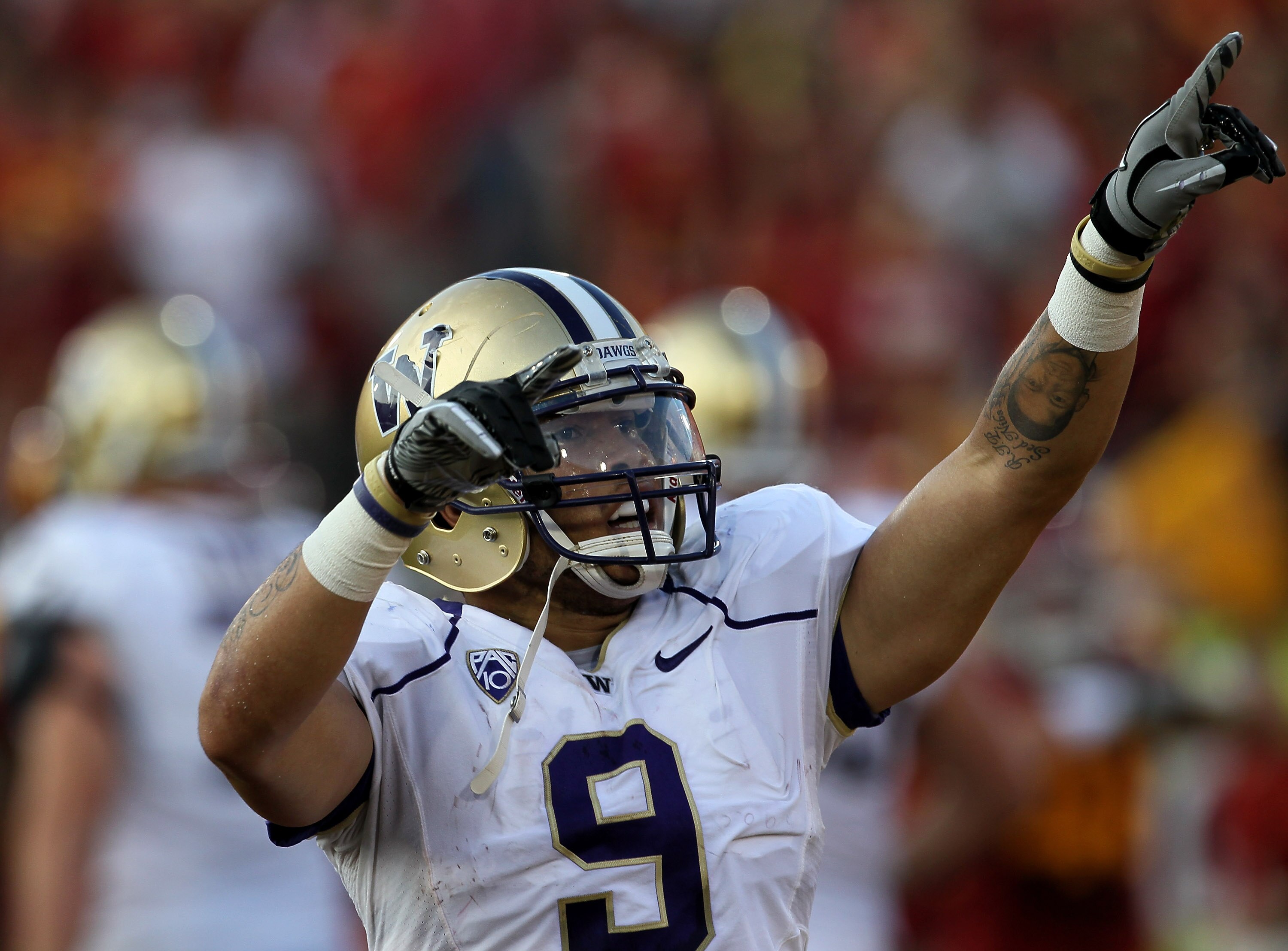 LOS ANGELES, CA - OCTOBER 02:  Wide Receiver Devin Aguilar #9 of the Washington Huskies celebrates his 44 yard touchdowch catch against the USC Trojans in the second quarter at the Los Angeles Memorial Coliseum on October 2, 2010 in Los Angeles, Californi
