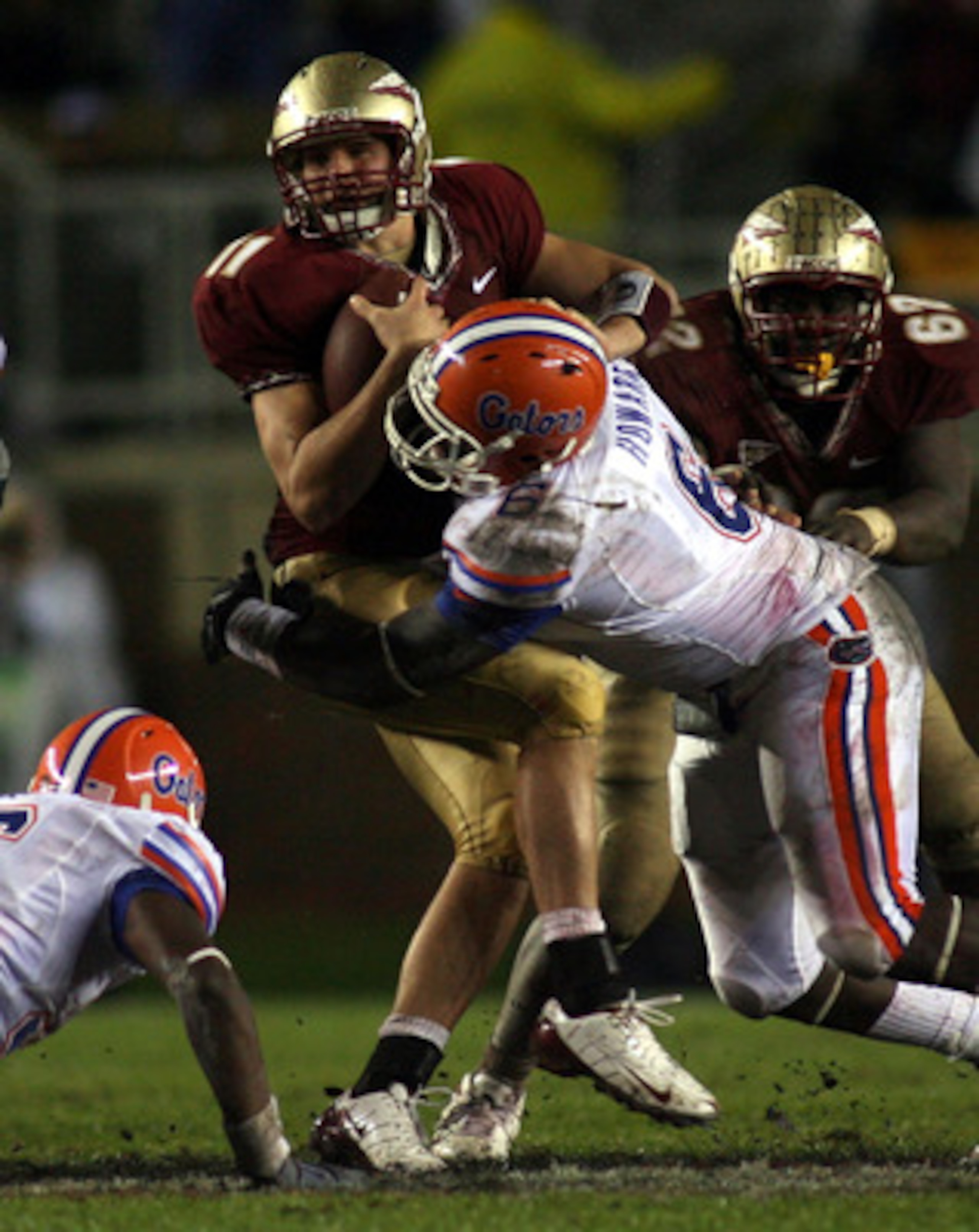 TALLAHASSEE, FL - NOVEMBER 29:  Quarterback Drew Weatherford #11 of the Florida State Seminoles is sacked by defensive end Jaye Howard #6 of the Florida Gators at Bobby Bowden Field at Doak Campbell Stadium on November 29, 2008 in Tallahassee, Florida. Th