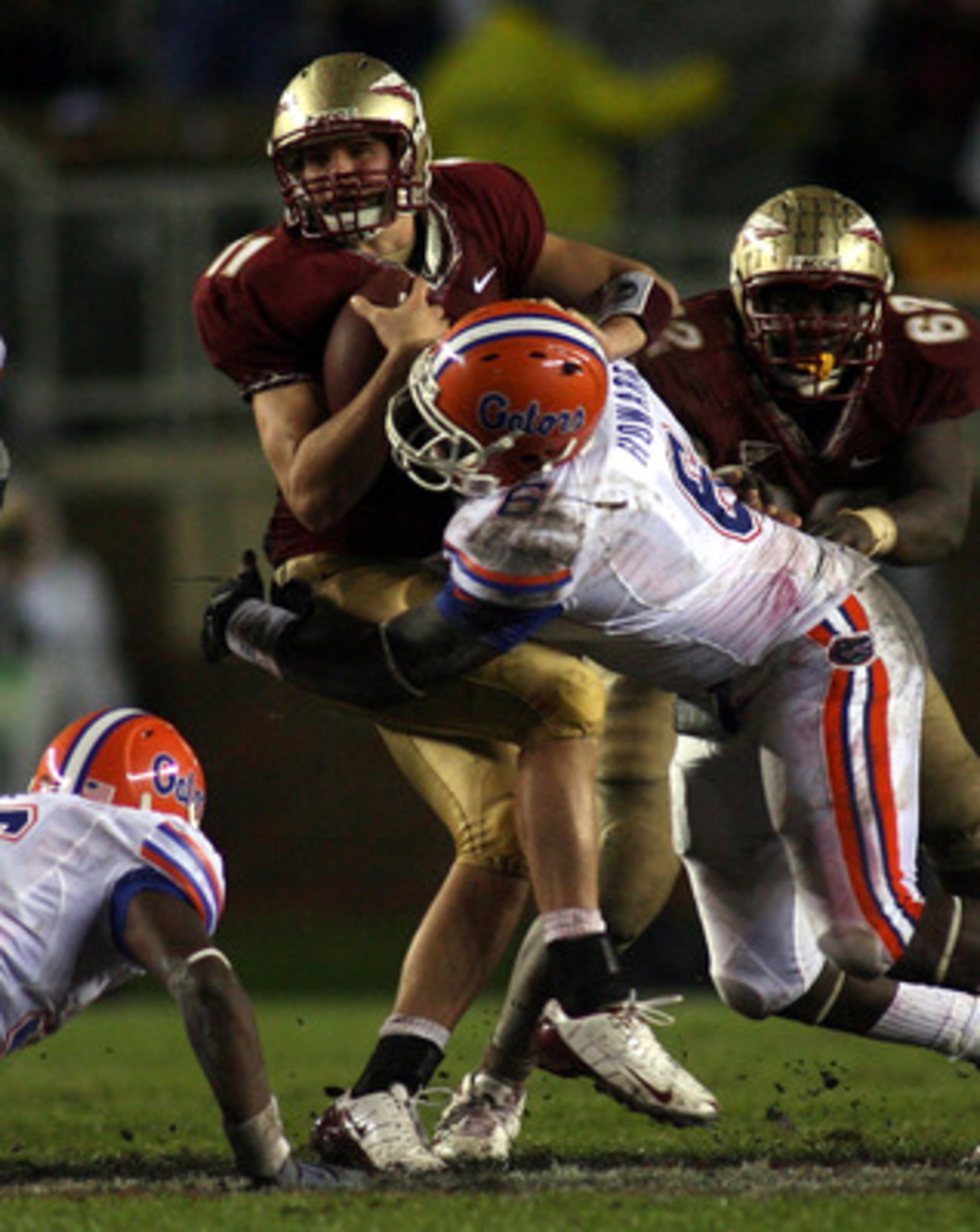 TALLAHASSEE, FL - NOVEMBER 29:  Quarterback Drew Weatherford #11 of the Florida State Seminoles is sacked by defensive end Jaye Howard #6 of the Florida Gators at Bobby Bowden Field at Doak Campbell Stadium on November 29, 2008 in Tallahassee, Florida. Th