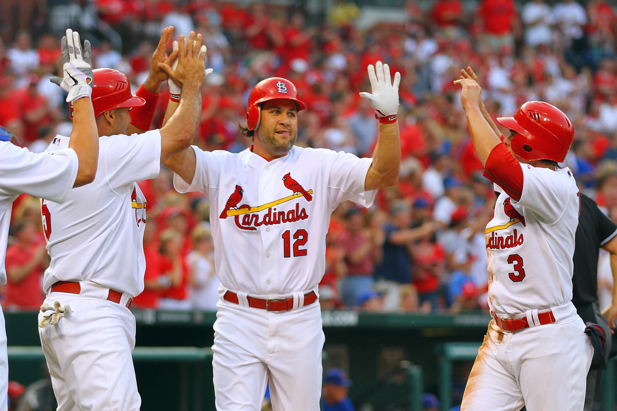 ST. LOUIS, MO - JUNE 3: Lance Berkman #12 of the St. Louis Cardinals is congratulated by teammates after hitting a three-run home run against the Chicago Cubs at Busch Stadium on June 3, 2011 in St. Louis, Missouri.  (Photo by Dilip Vishwanat/Getty Images