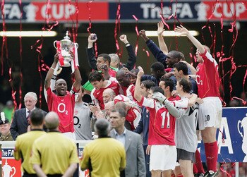 CARDIFF, UNITED KINGDOM - MAY 21: Arsenal captain, Patrick Vieira, holds the trophy aloft as team mates celebrate after winning the FA Cup Final between Arsenal and Manchester United 5-4 on penalty's at The Millennium Stadium on May 21, 2005 in Cardiff, W